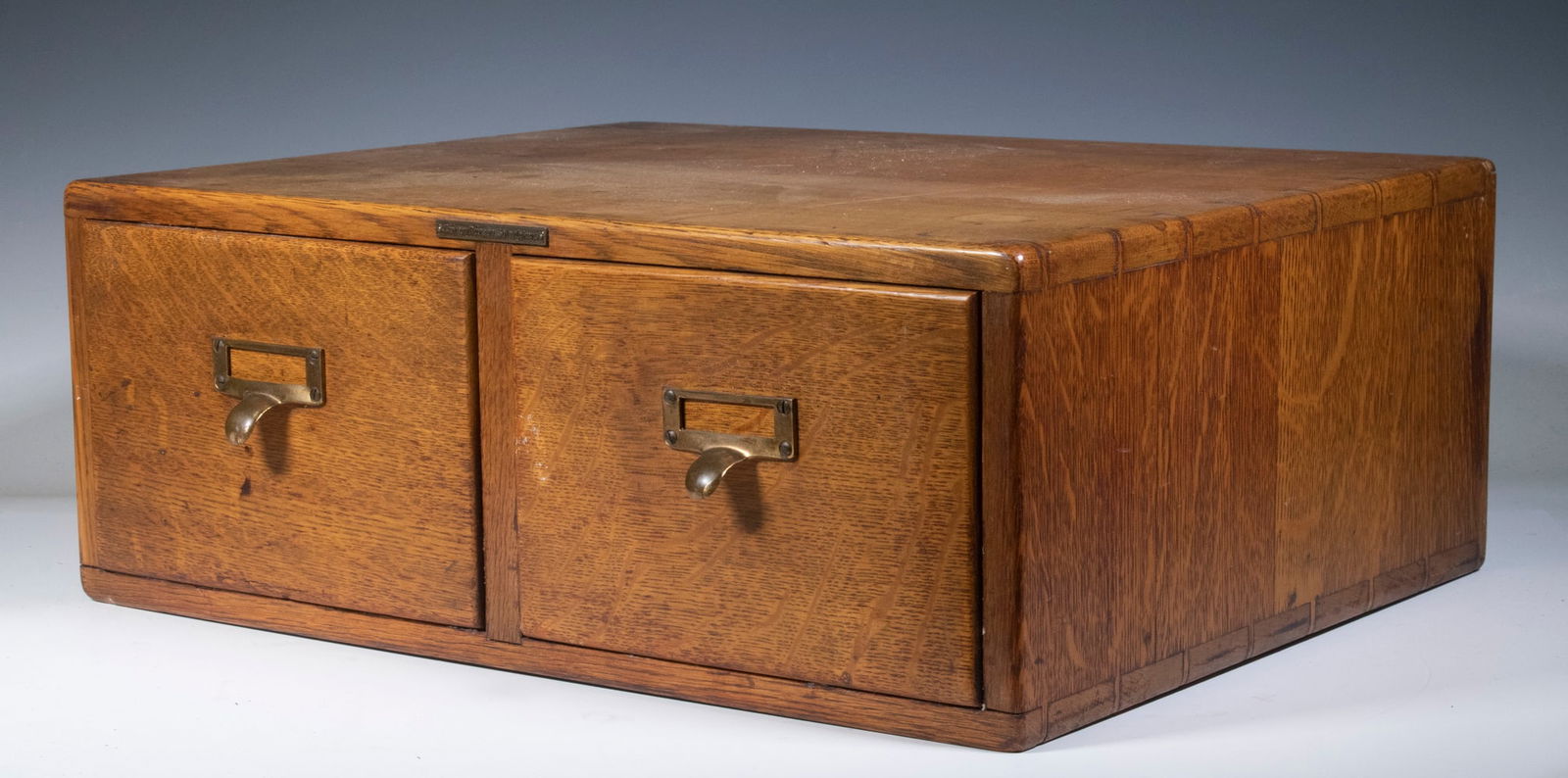 CIRCA 1910 GOLDEN OAK TWO-DRAWER FILE CASE, EMPTY: CIRCA 1910 GOLDEN OAK TWO-DRAWER FILE CASE, EMPTY Plain unmarked file box, circa 1925, brass thumb pulls, dovetailed. good condition OS: 7 1/2 x 16 x 20 in. (19.1 x 40.6 x 50.8 cm.)