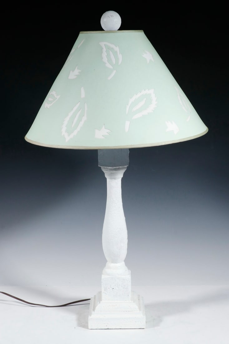 WHITE PAINTED WOODEN TABLE LAMP: WHITE PAINTED WOODEN TABLE LAMP Vintage Turned Wooden Lamp, with square base and green cardboard cutout leaf design lampshade, single socket fixture with harp and matching white finial. Minor paint