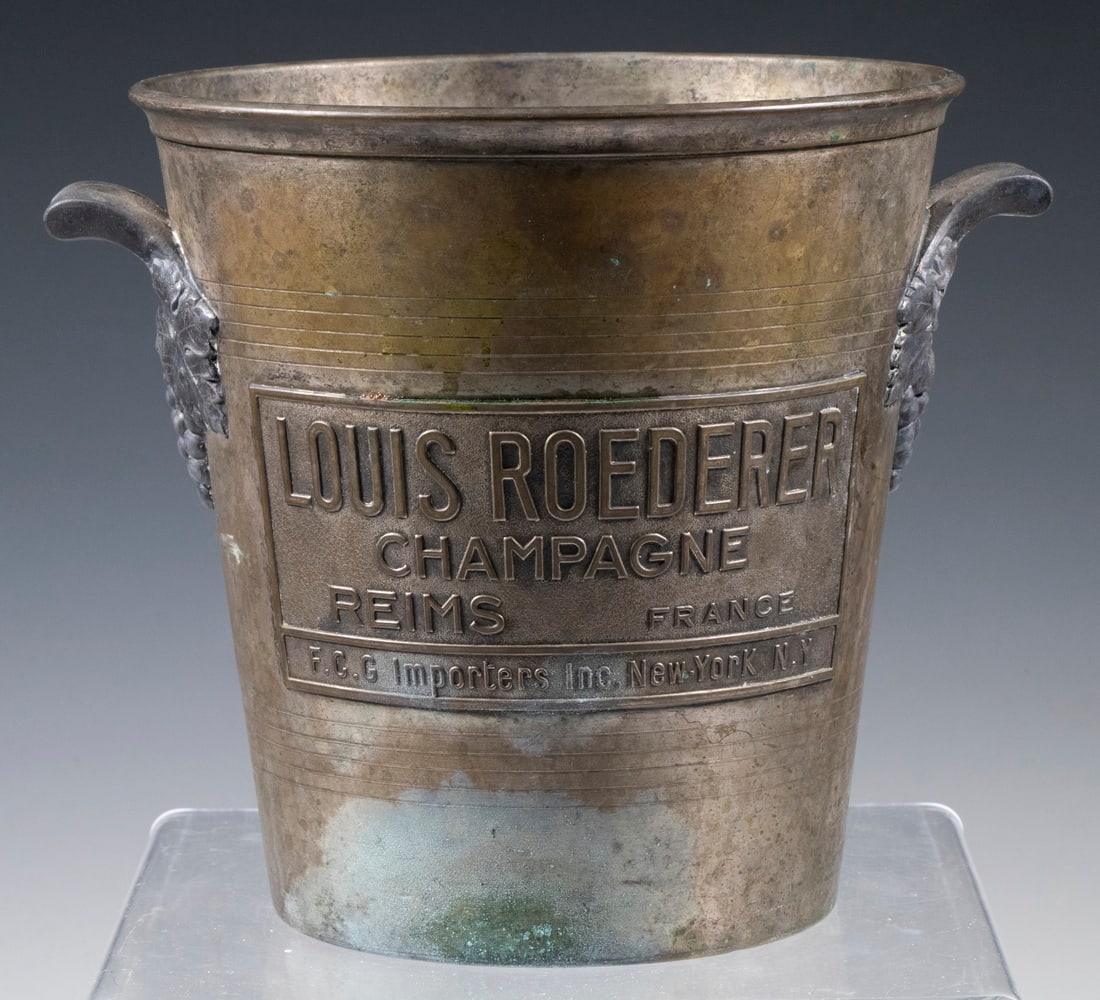 VINTAGE LOUIS ROEDERER ICE BUCKET: VINTAGE LOUIS ROEDERER ICE BUCKET Metal Champagne Bucket, with grapevine form side handles, with embossed label of "Louis Roederer Champagne, Reims, France, R.C.G. Importers Inc., New York, NY".