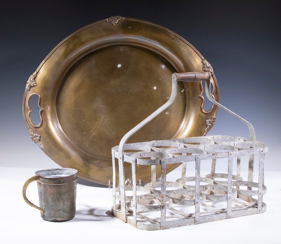 (3) DECORATIVE METAL HOME ACCESSORIES: (3) DECORATIVE METAL HOME ACCESSORIES Metal wine bottle carrier, with wooden top handle, holds eight bottles, with weathered surface, 15 1/4" high, 17 1/2" x 8 1/2"; Large oval Indian brass serving