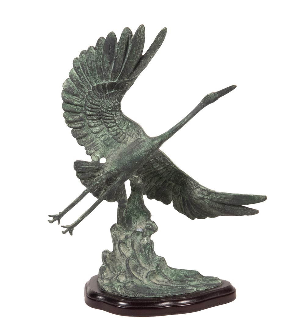 KOREAN CRANE SCULPTURE: KOREAN CRANE SCULPTURE Crane Taking Flight from a Wave, cast and patinated bronze, unsigned. With label from Toyo of Korea on bottom of mahogany base. Size: 14 x 4 x 11 in. (35.6 x 10.2 x 27.9 cm.)