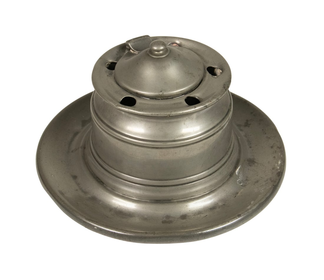 CAPSTAN FORM PEWTER INKWELL: CAPSTAN FORM PEWTER INKWELL Pewter Inkwell with hinged lid, six quill holes, glass liner, with attached dish form base. Size: 4 x 7 x 7 in. (10.2 x 17.8 x 17.8 cm.)