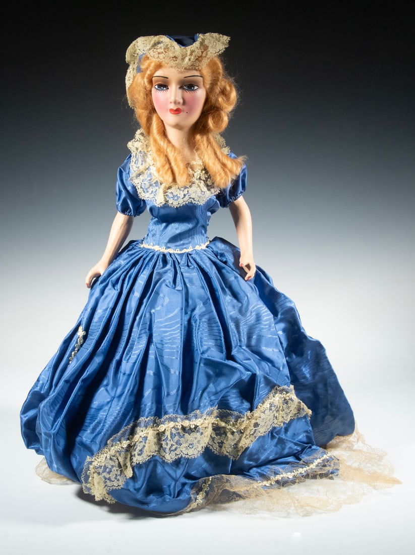 CIRCA 1930 AMERICAN BOUDOIR DOLL: CIRCA 1930 AMERICAN BOUDOIR DOLL Hollywood Blonde with painted compo head, hands and feet, in a blue silk taffeta dress and bonnet with white lace trim. In the original cardboard box. Height: 30 in.