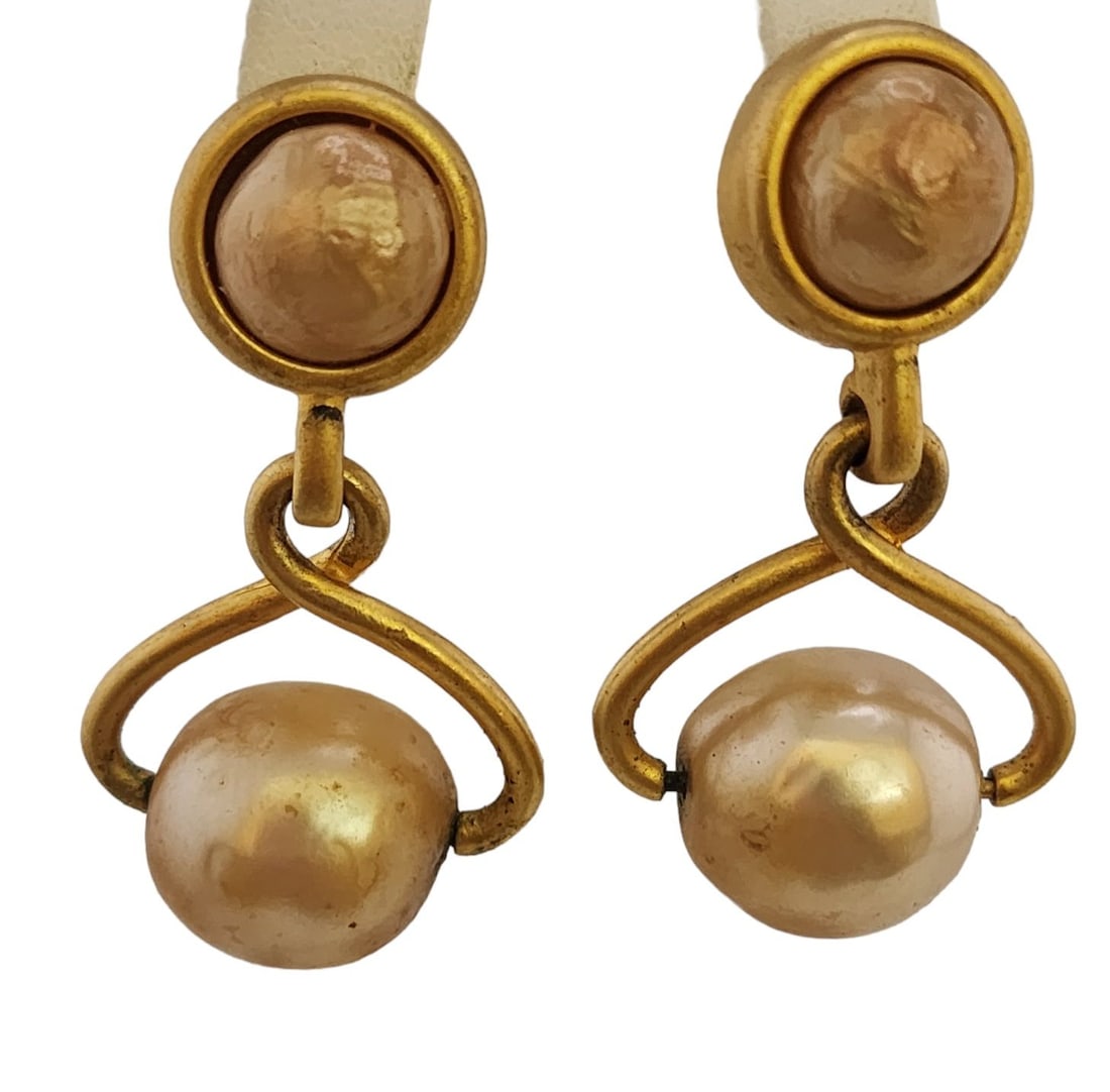 VINTAGE SIGNED KARL LAGERFELD RUNWAY COUTURE ICE TONG FAUX PEARL CLIP EARRINGS: SIZE: 2.25" COLOR: GOLD CONDITION: GOOD VINTAGE; ONE EARRING HAS SOME PLATING MISSING AT THE TOP, SOME MARKS AND A LITTLE PEARL COAT LOSS TO THE PEARLS AT THE BOTTOM. SIGNED: KL (KARL LAGERFELD)