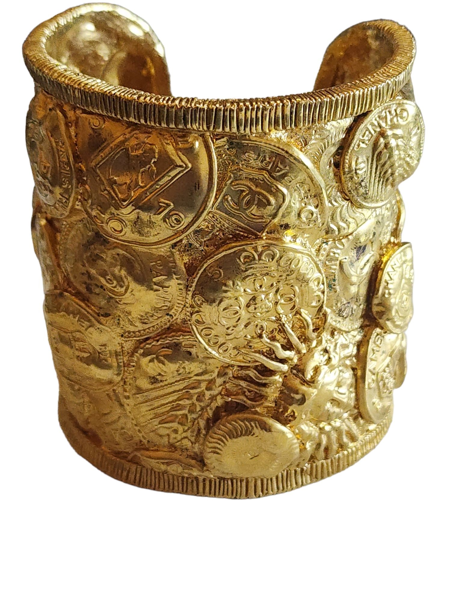 RARE CHANEL GILT 1993 CRUISE HEAVY OVERLAPPING COIN WIDE CUFF BRACELET: Rare Chanel Gilt 1993 Cruise Heavy Overlapping Coin Wide Cuff BraceletAmazing gilt finish and details. Very, very heavy piece.Size: 2.75" wide, does not have much give to open; opening is 1"Color: Gol