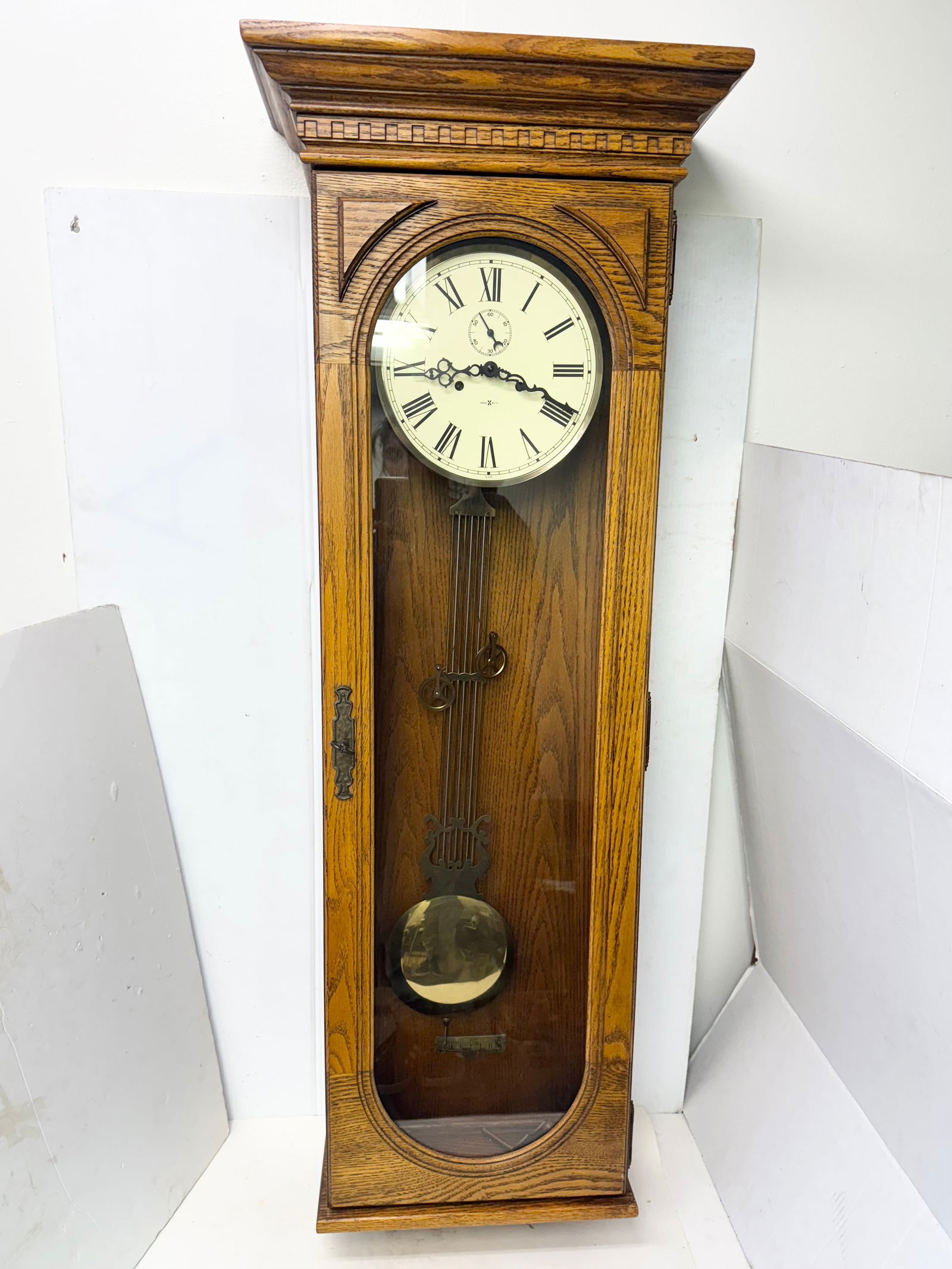 Howard Miller Large Weighted Wall Clock Model 612 Gong Strike: Howard Miller Large Weighted Wall Clock Model 612 Gong StrikeSigned Howard Miller. Model 612. Hanging pendulum and two weights. Crank and key at bottom. Large hinged glass door with key that locks. We