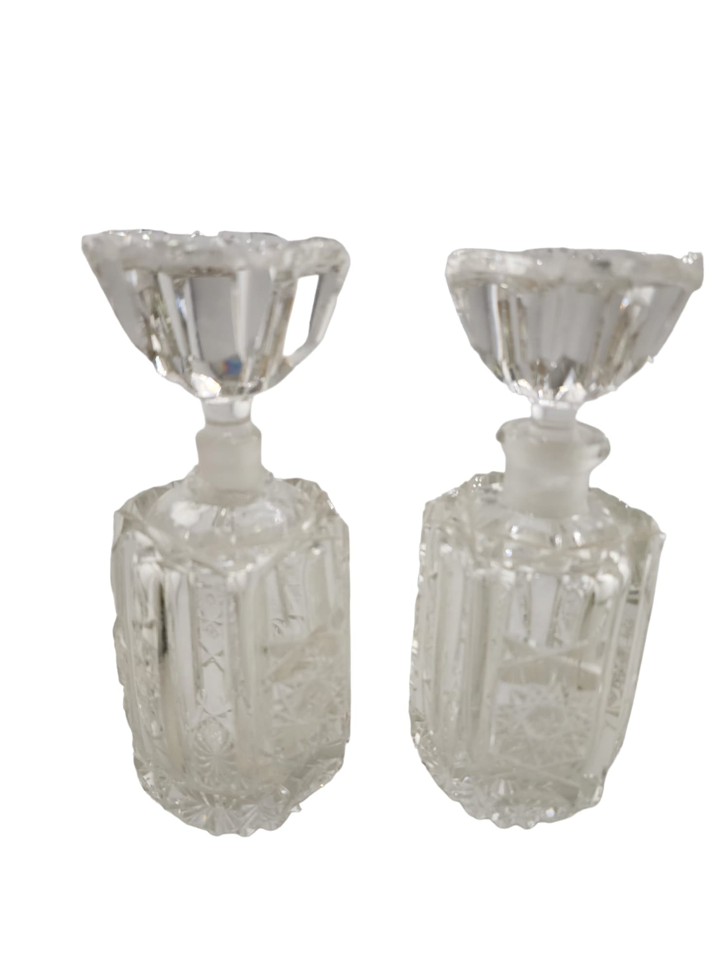 PAIR OF VINTAGE DECORATIVE CUT CRYSTAL PERFUME BOTTLES- AS IS: PAIR OF VINTAGE DECORATIVE CUT CRYSTAL PERFUME BOTTLES- AS IS THE BOTTLES ARE BEAUTIFUL, BUT UNFORTUNATELY BOTH HAVE SOME DAMAGE. 1 BOTTLE TOP IS CHIPPED ON THE RIM SOMEWHAT EXTENSIVELY. THE STOPPER P