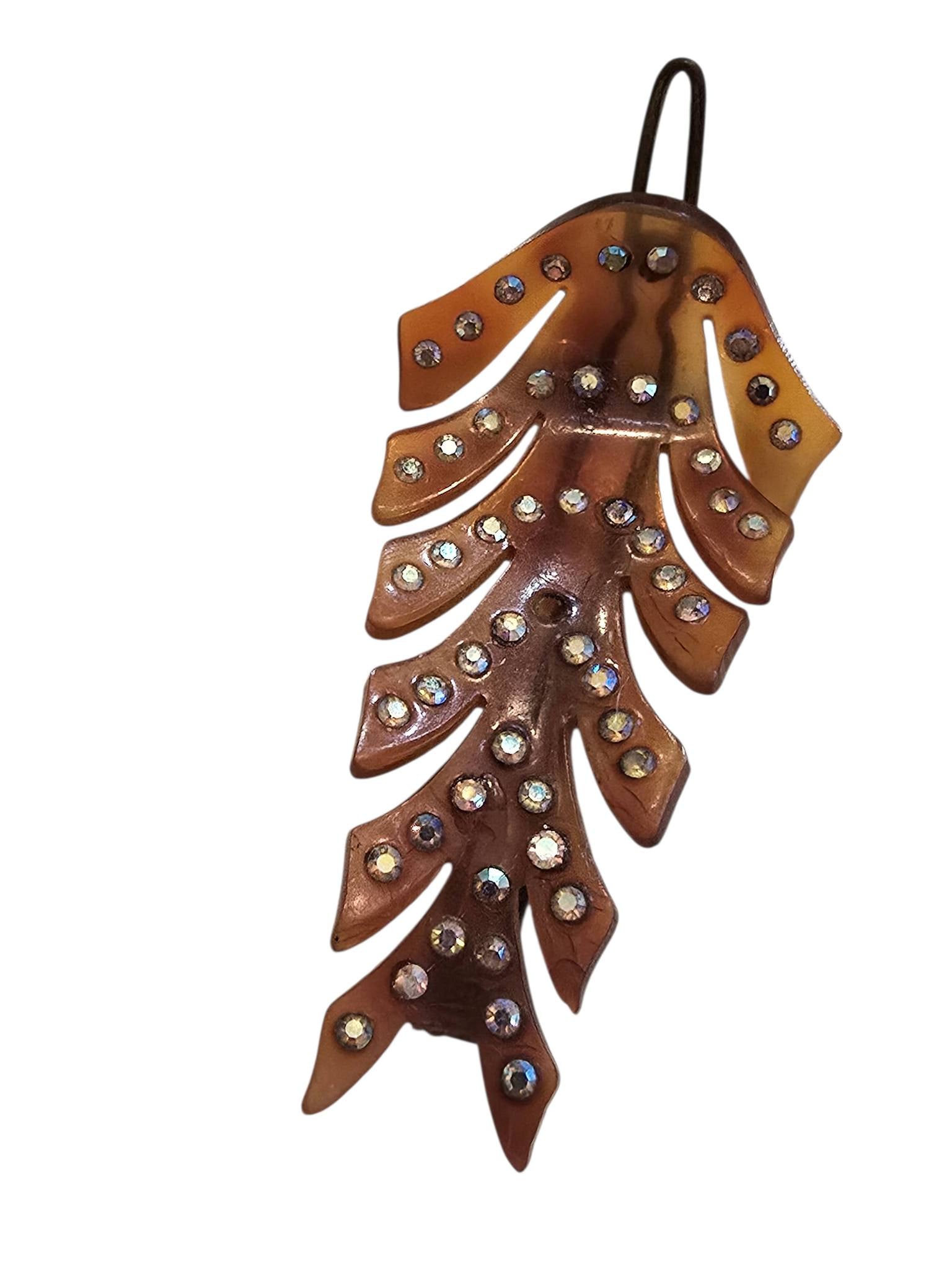 EARLY PLASTIC AND RHINESTONE LEAF BARETTE: EARLY PLASTIC AND RHINESTONE LEAF BARETTE, 2.5", 1 RHINESTONE MISSING, BRASS BACKED