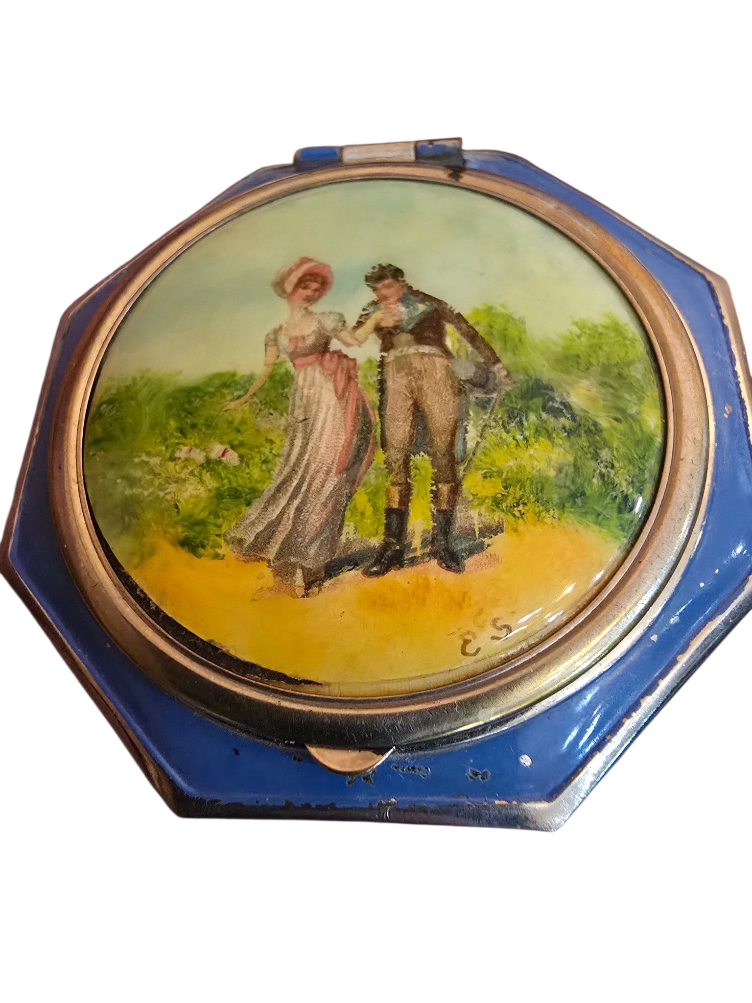 VINTAGE ENAMEL PORTRAIT COMPACT: VINTAGE ENAMEL PORTRAIT COMPACT. ITS 2.5", STILL HAS SOME OF THE ORIGINAL MAKE UP IN IT. NOT SIGNED, THERE ARE SMALL SPOTS OF ENAMEL LOSS TO THE BLUE FRONT.