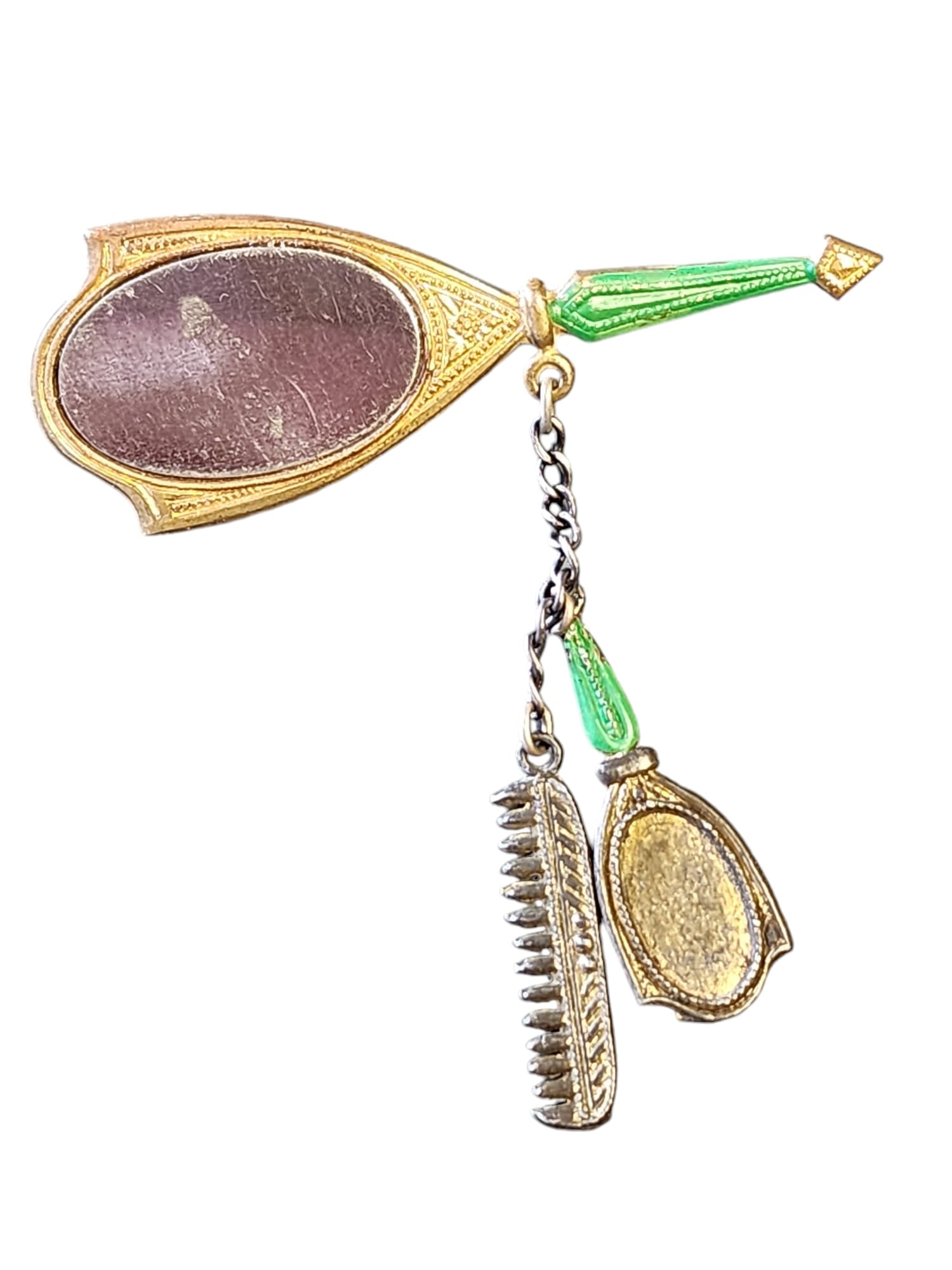 SUPER CUTE MIRROR WITH BRUSH AND COMB DANGLING BROOCH: Super Cute Mirror with Brush and Comb Dangling Brooch (A5668)Size: 2.25" down by 2.5"Color: Gold, GreenCondition: Very good vintageSigned: NoneDetails: Has c clasp closure, marks to the faux mirror,