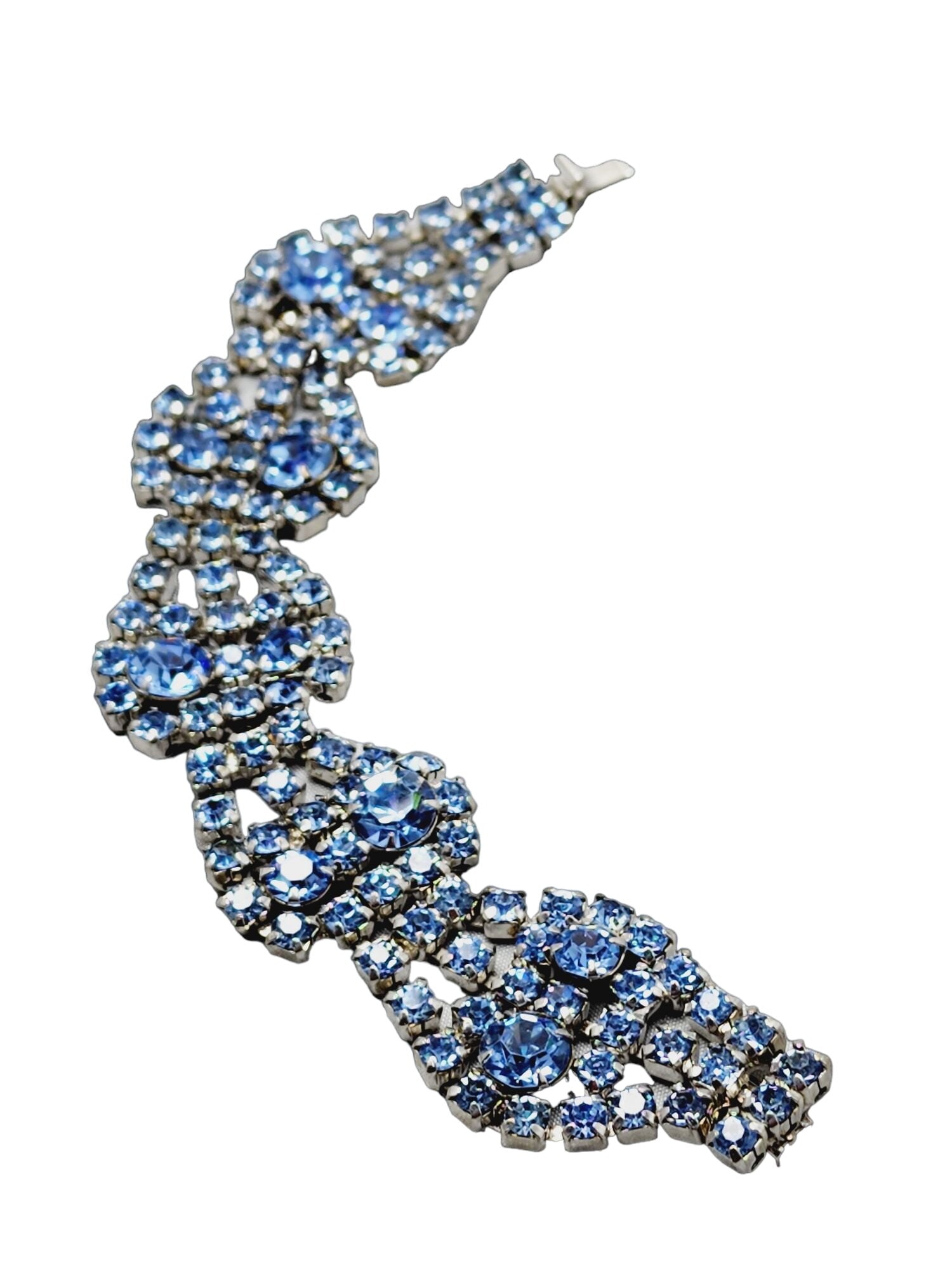Vintage Signed Kramer Rhinestone Bracelet: Vintage Signed Kramer Rhinestone Bracelet (A1394) Size: 7.25" Color: Blue Condition: Good vintage; one rhinestone is not soldered to the rest of the bracelet; look at close-up pictures. Era: Circa 195