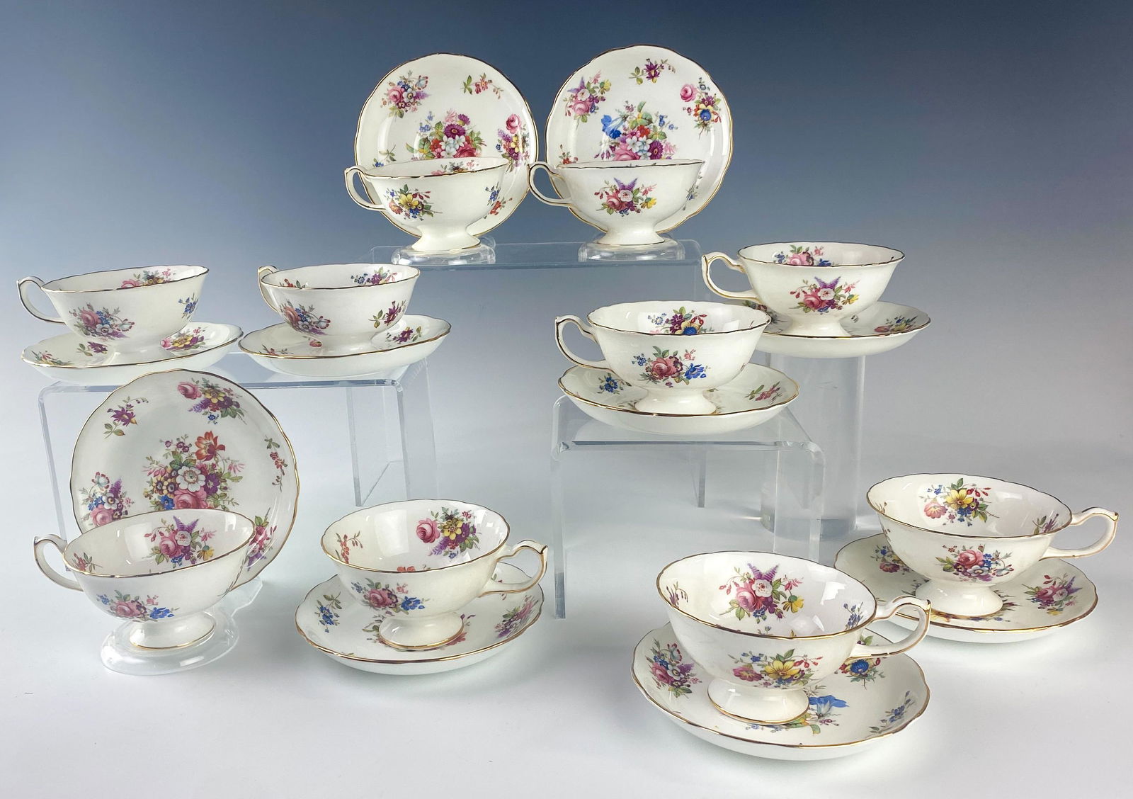 Hammersley Bone China Floral Tea Cup Saucer SET 10: Hammersley (English). Minuet discontinued 20th Century pattern. Hand painted central flora against a white ground. Warmly glazed. Borders, foot and handle of cup with gold trim. Good estate fresh cond