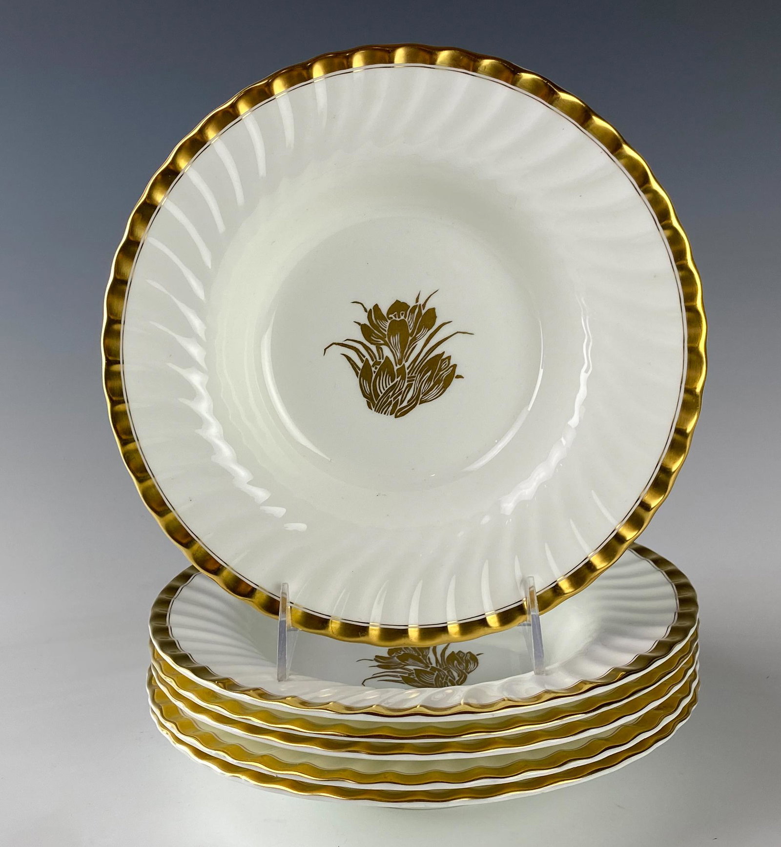 Minton Bone China Gold Crocus Rimmed Soup Bowl SET: Minton (English). Set of six bone china bowls in the Gold Crocus pattern, introduced 1940 and retired 1969. Gold floral design to the center against a white ground. Slanted ribbed border with gold tri