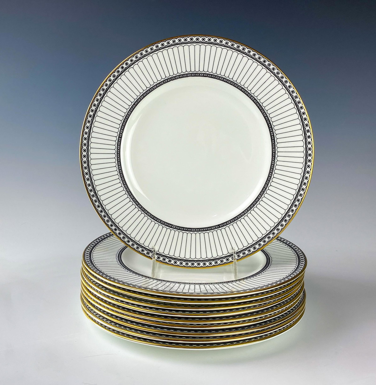 Wedgwood Bone China Colonnade Dinner Plates SET 10: Wedgwood (English). Black geometric line design with circles around border, rim with a gold trim. Pattern introduced 1960, retired 2004. Warm glazed finish. Signed with black urn stamp WEDGWOOD BONE C