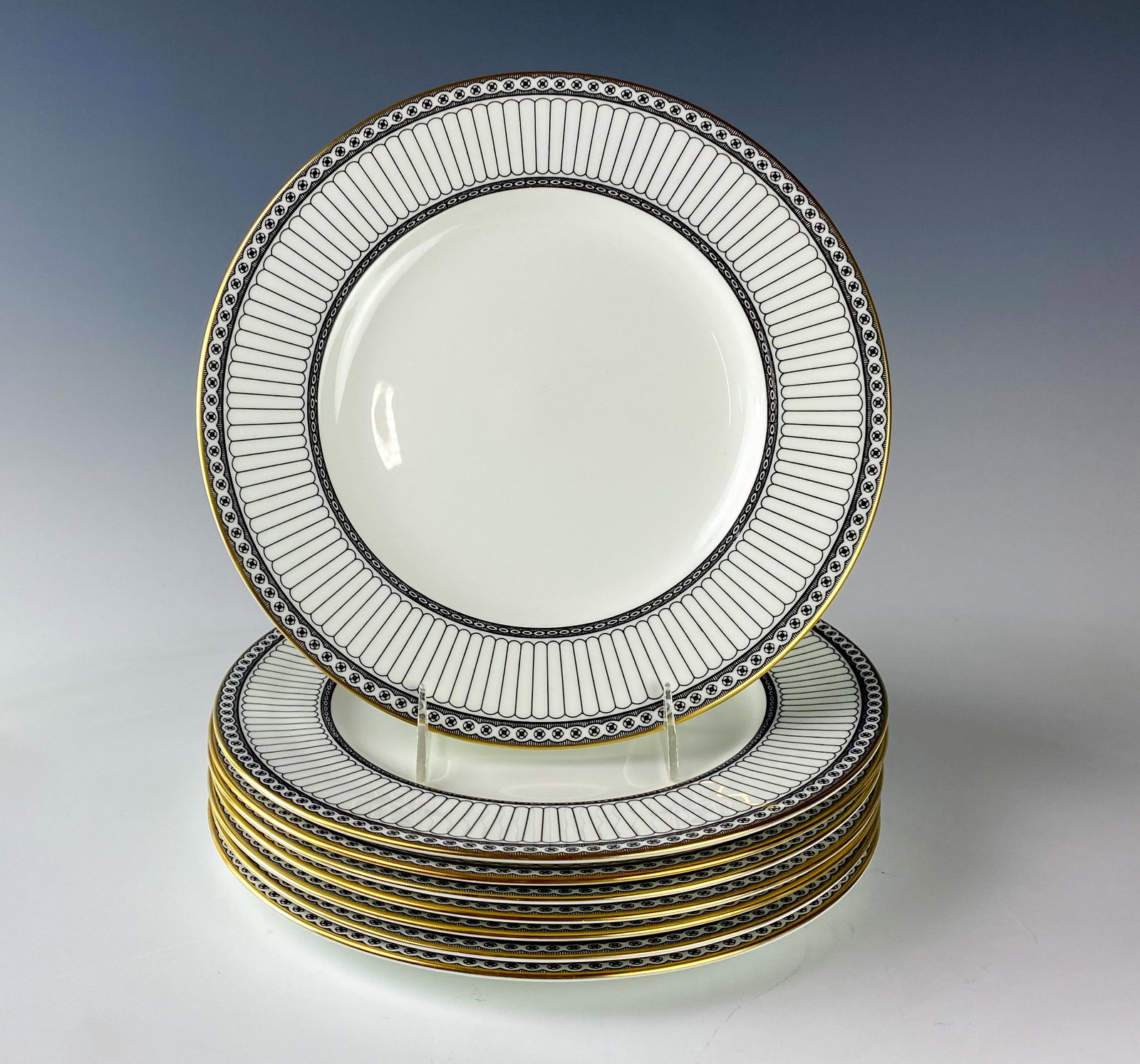Wedgwood Bone China Colonnade Dinner Plates SET 8: Wedgwood (English). Black geometric line design with circles around border, rim with a gold trim. Pattern introduced 1960, retired 2004. Warm glazed finish. Signed with black urn stamp WEDGWOOD BONE C