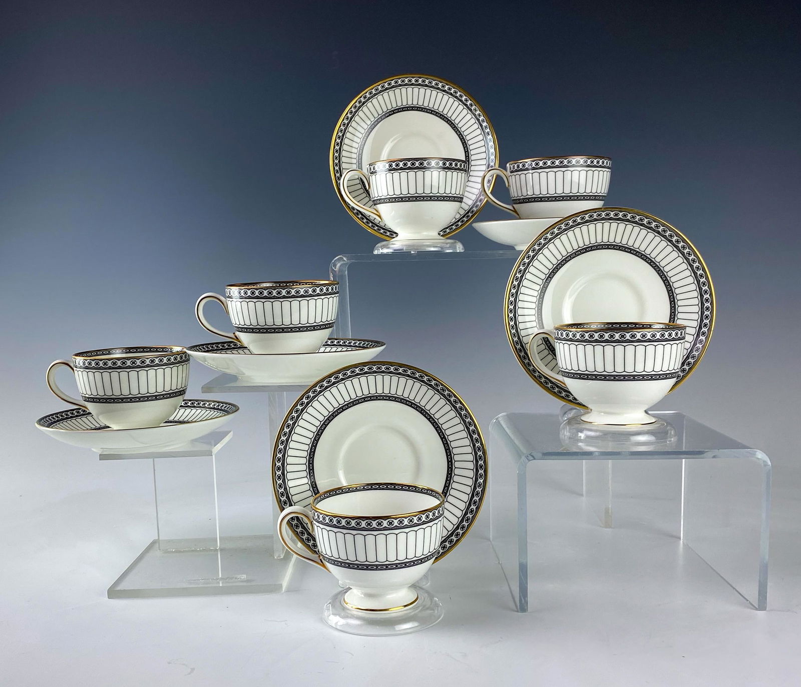 Wedgwood Bone China Colonnade Tea Cup Saucer SET 6: Wedgwood (English). Black geometric line design with circles around border, rim with a gold trim. Pattern introduced 1960, retired 2004. Warm glazed finish. Signed with black urn stamp WEDGWOOD BONE C