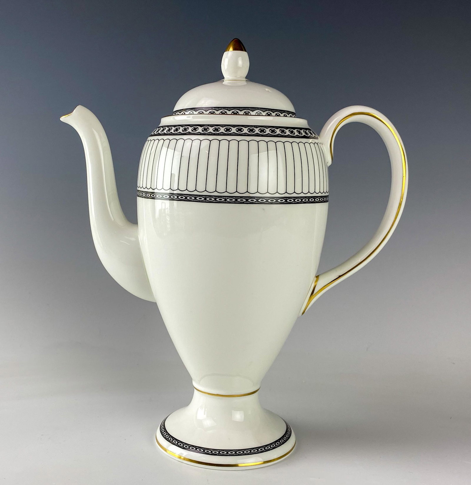 Wedgwood Bone China Colonnade Coffee Tea Pot & Lid: Wedgwood (English). Black geometric line design with circles around border, rim with a gold trim. Pattern introduced 1960, retired 2004. Warm glazed finish. Signed with black urn stamp WEDGWOOD BONE C