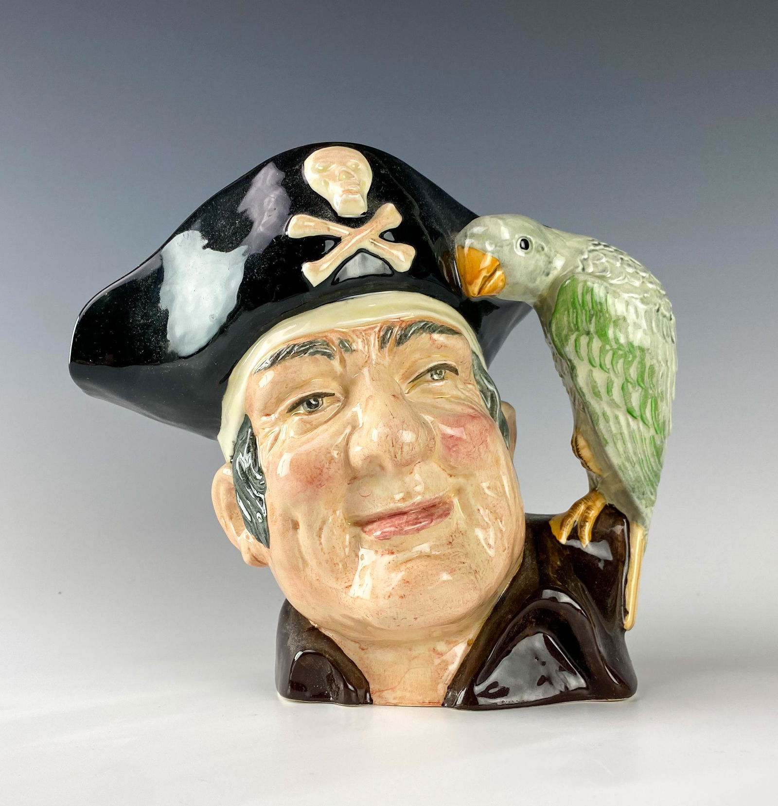 Royal Doulton Long John Silver D6335 Toby Jug Mug: Royal Doulton (English). Large retired bone china character toby jug mug, Long John Silver D6335. Designed by artist Max Henk, introduced in 1952. Good estate fresh condition. Measures 7 1/4 in. Signe