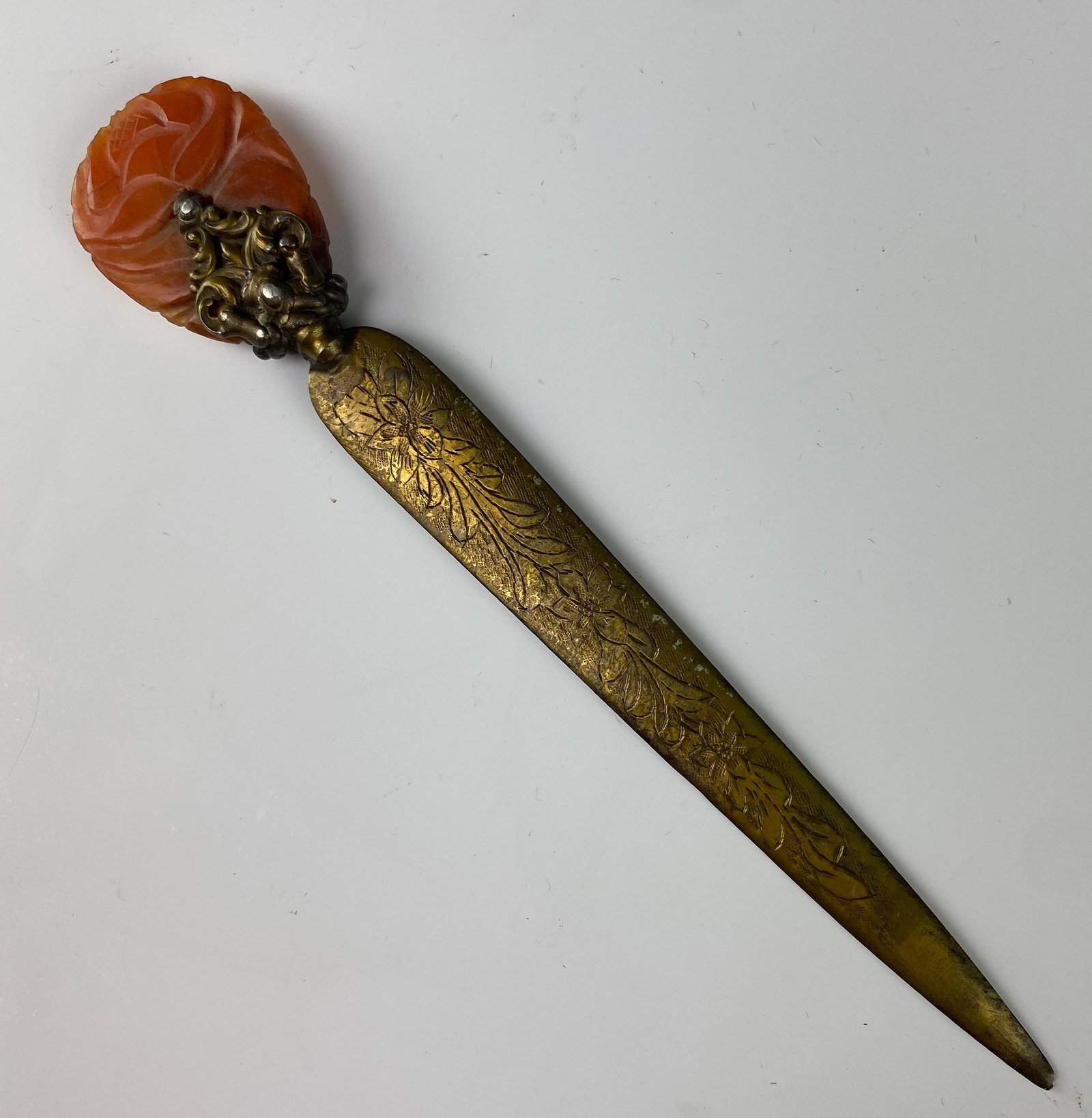 Carved Carnelian Etched Floral Brass Letter Opener: Carved carnelian hardstone handle in rose motif, raised scroll design to hardware, gilt brass blade with etched floral pattern on one side. Original aged patina. Good estate fresh condition. Surface l