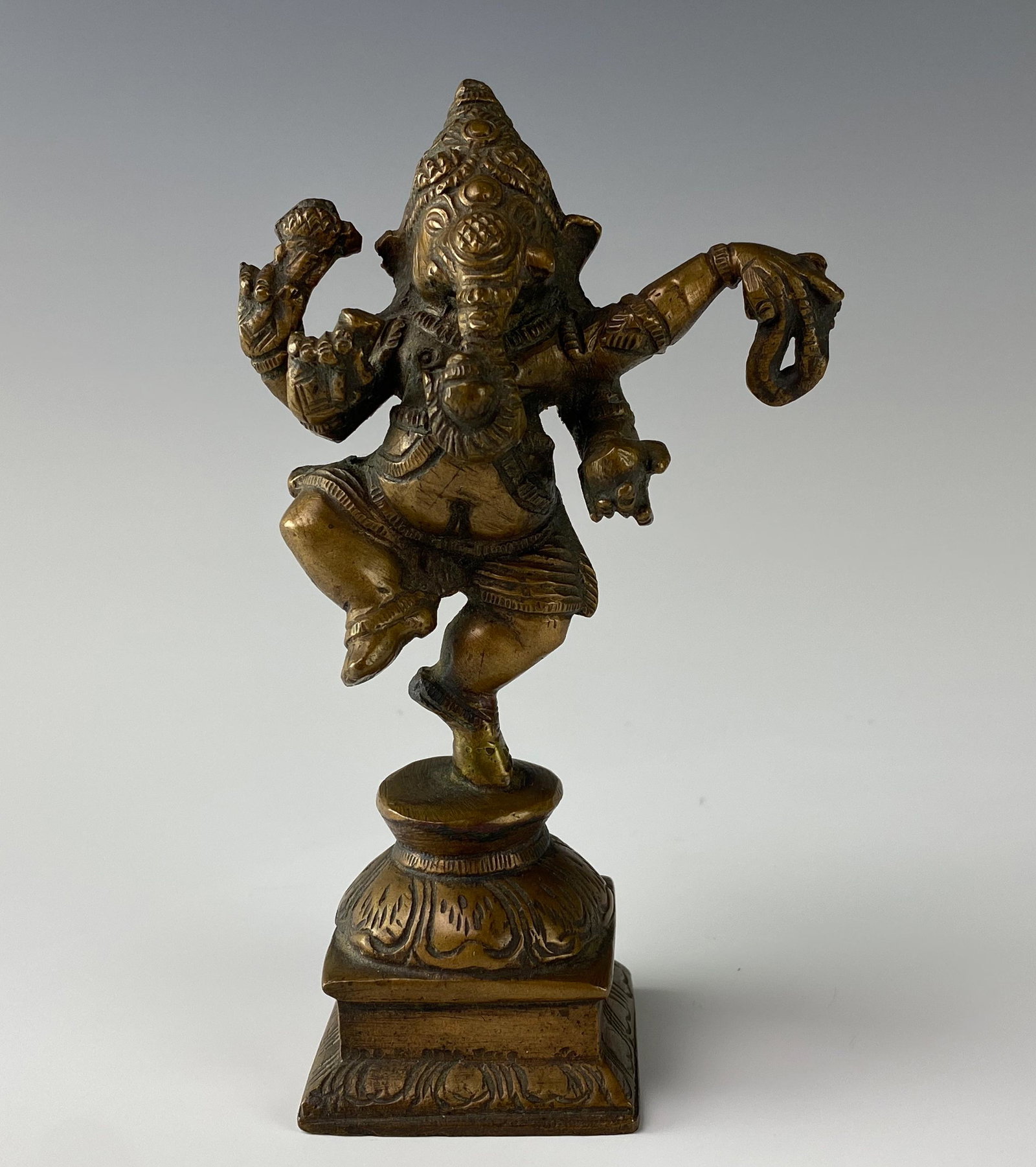 Bronze Ganesha India Hindu Wisdom Deity Sculpture: Bronze statue modeled as Ganesha, the elephant headed Hindu Indian divinity associated with wisdom, the arts, science and the intellect. In standing pose, surmounted atop a stepped square base. Good e