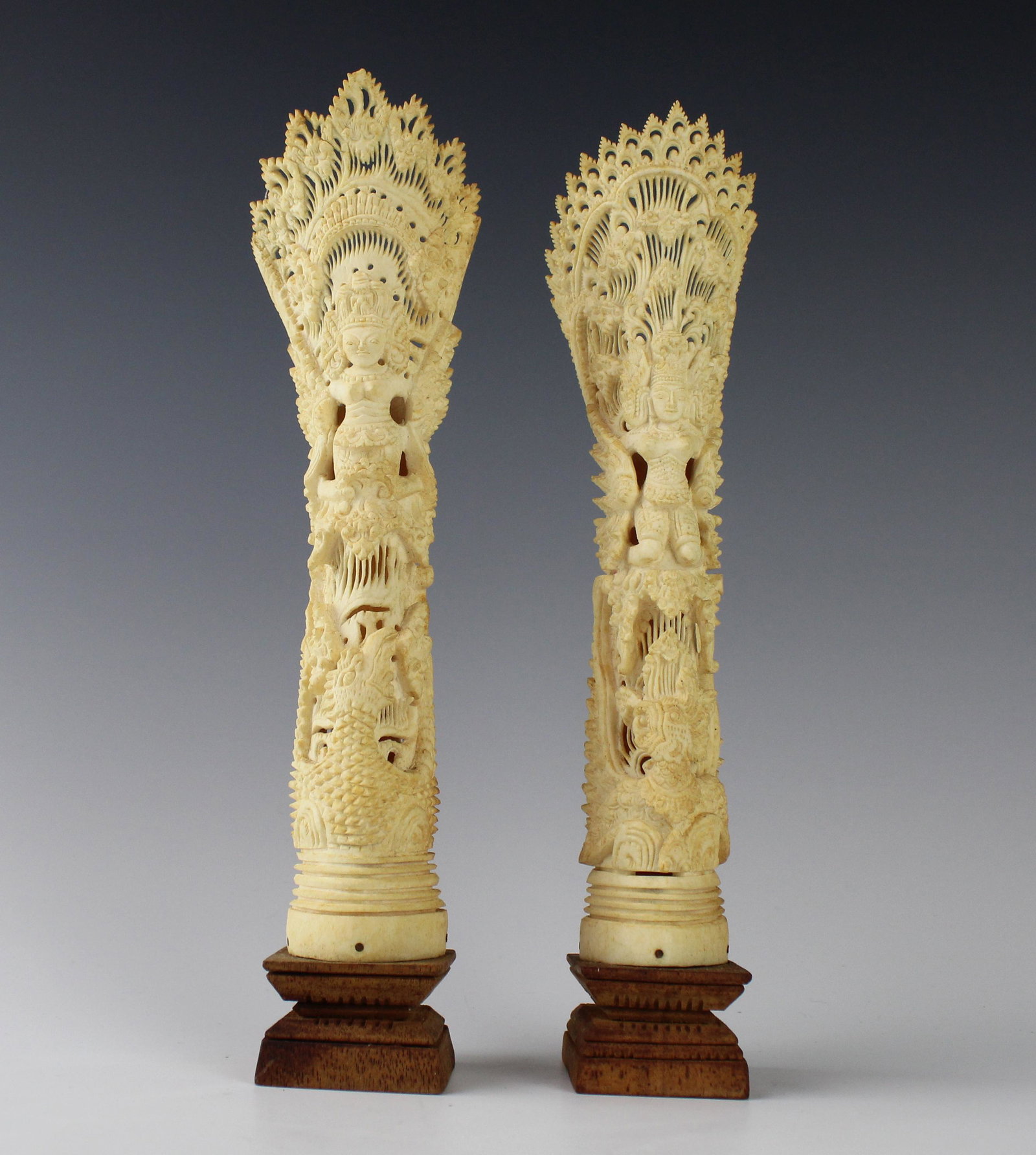 Indonesian Carved Divinity Dragon Bone Sculptures: Hand carved, each depicting an allegorical figure with dragon, bird and divine details. Well made. Mounted on a dark wood base. Good estate fresh condition. Measures 10 3/8 in. x 1 3/4 in. x 2 1/4 in.