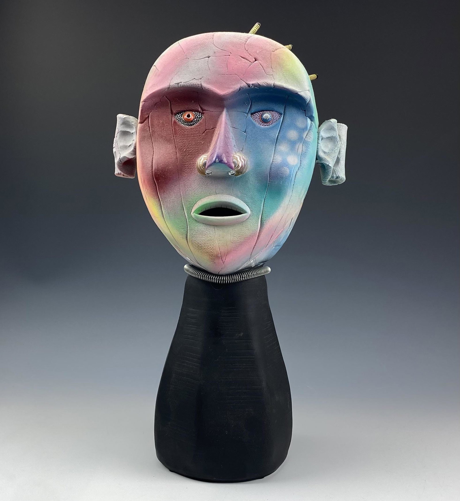Modernist Mixed Media Signed Head Bust Sculpture: Unique and distinctive article of studio hand crafted mixed media artistry. Features a bust of a supernatural alien form with open mouth, wire coil around neck and metallic striped accents on the head