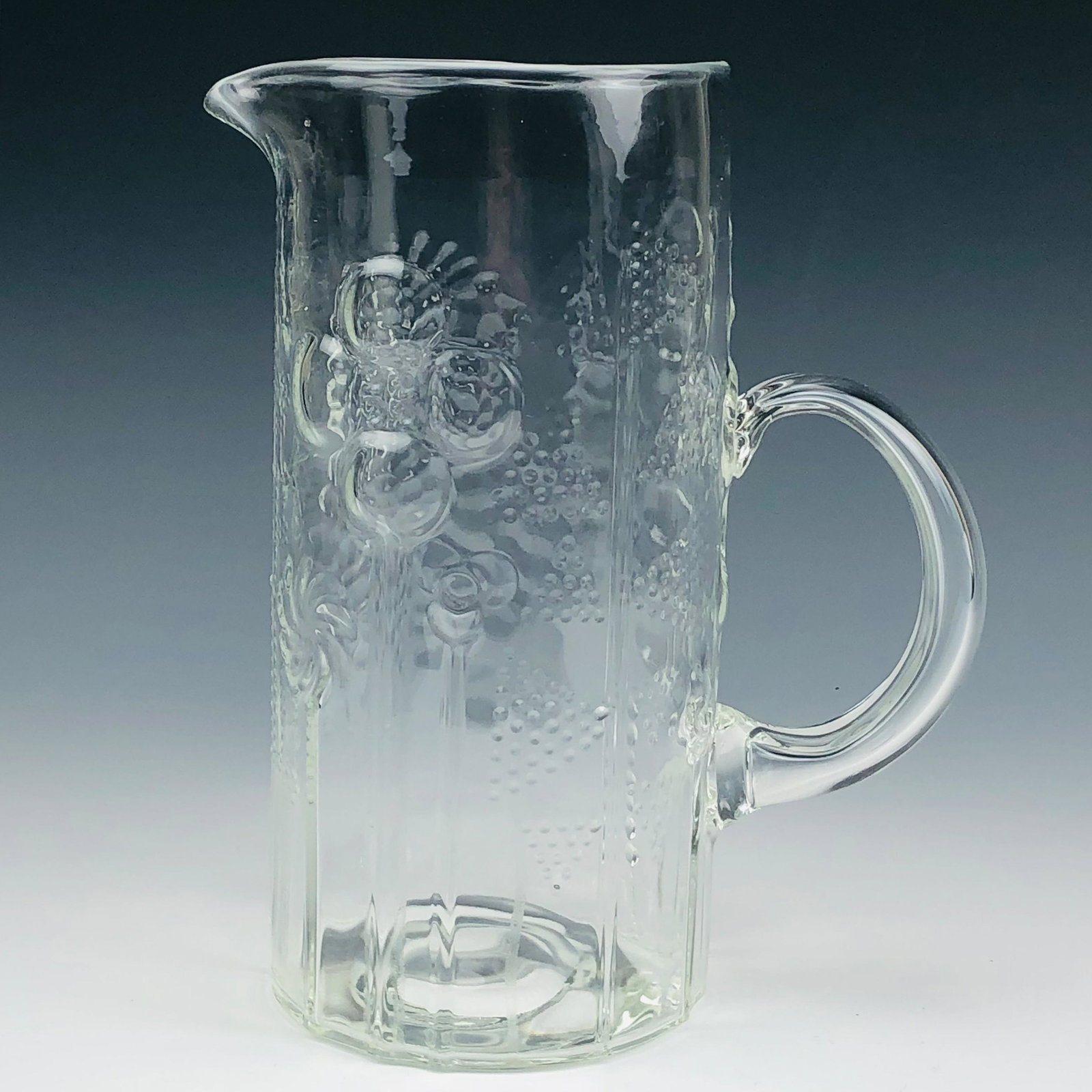 Iittala Finland Oiva Toikka "Flora" Glass Pitcher: Iittala Finland Mid Century Modern MCM Glass Pitcher Jug. Designer : Oiva Toikka [1931-2019] ~ internationally renowned and well respected Finnish glass artist / sculptor / designer. Pattern : Flora. 