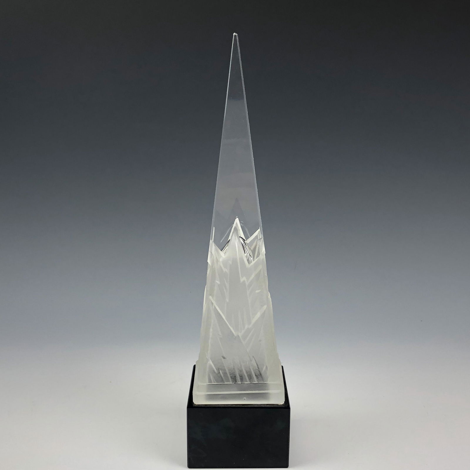 Art Deco Frosted Glass Obelisk Icicle Sculpture: High quality glass sculpture. Modeled with a strongly influenced Art Deco approach. Design features an obelisk with a partially clear and a partially frosted body, the lower area with a raised mountai