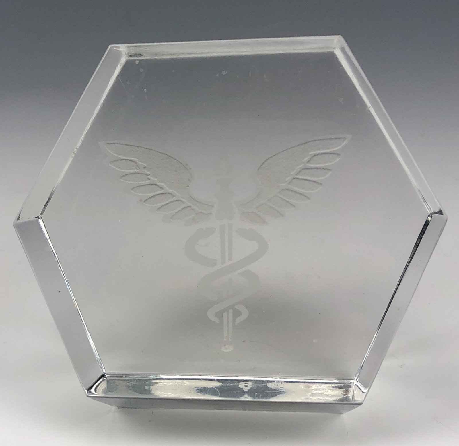 Baccarat French Crystal Caduceus Desk Paperweight: Baccarat France French Crystal Art Glass Hexagonal Desk Table Paperweight. Front features an engraved Caduceus ~ a short staff entwined by two serpents surmounted by wings. This symbolic object has ma