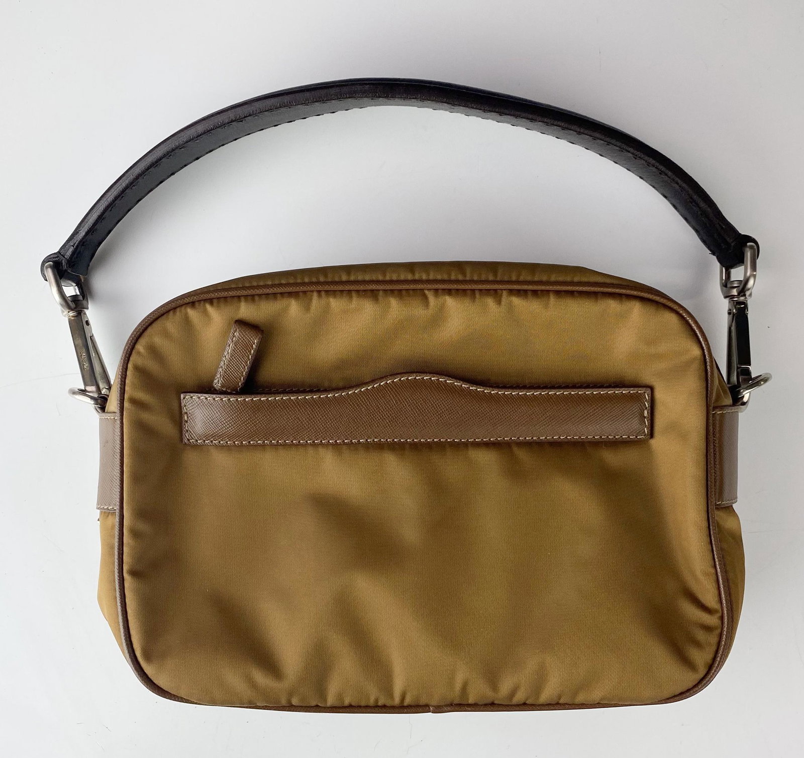 Prada Italy Brown Nylon Fabric Shoulder Purse Bag: This authentic shoulder bag features a nylon body with leather trim, an exterior zippered pocket, flat leather strap, top zippered closure and one single zippered interior compartment with tonal jacqu
