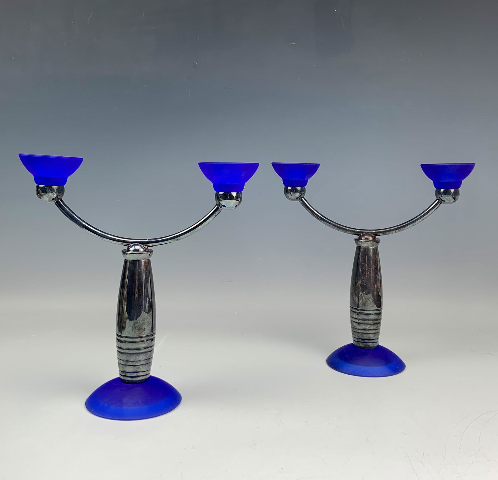 Christofle Pr Signed Art Deco Mantle Candleholders: Features a pair of Christofle France Art Deco Style glass and metal candleholders. Each designed to hold 2 candles, Modeled with frosted glass cup holders, silver plated arms, a partially ribbed body