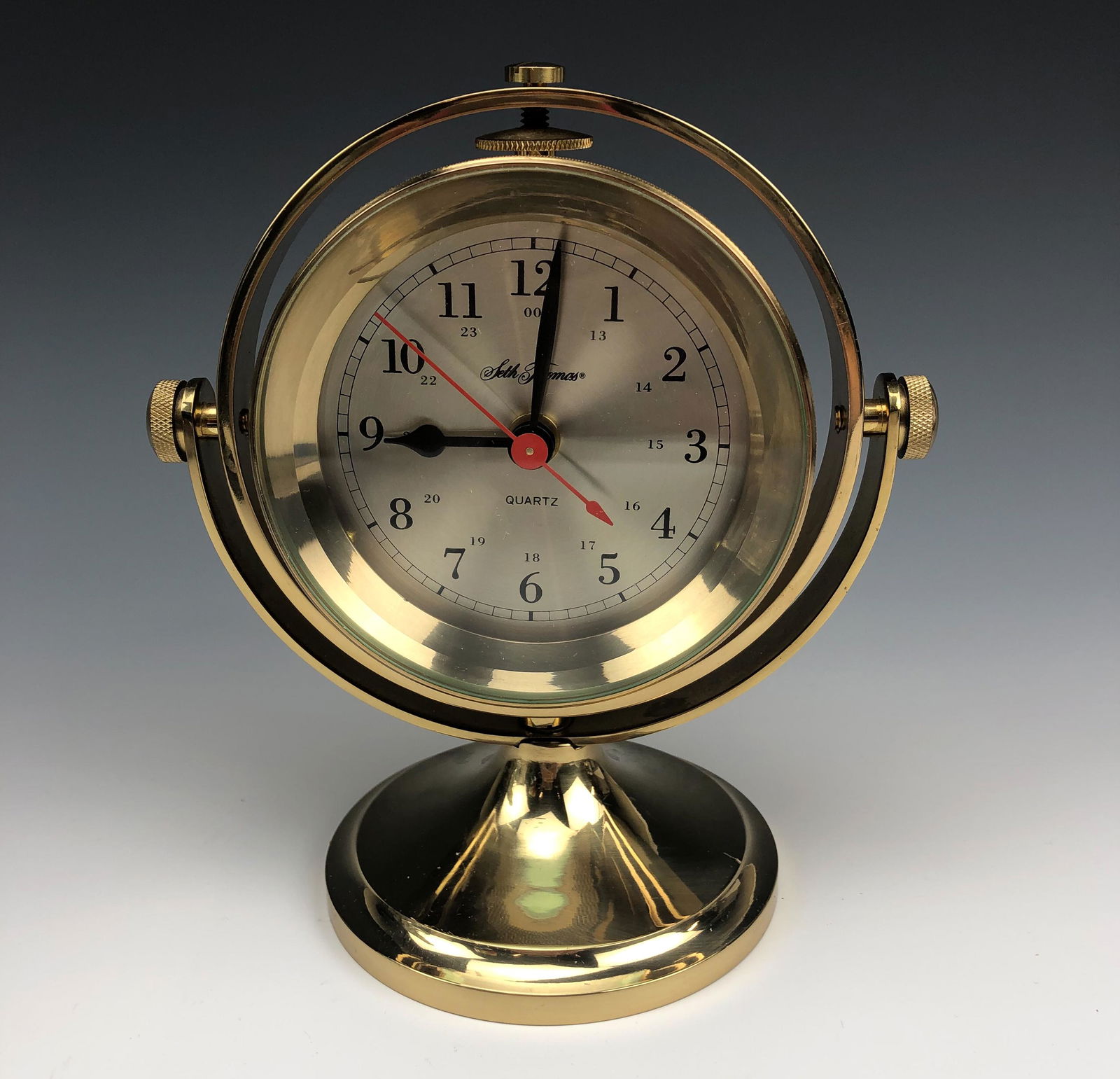 Seth Thomas Nautical Brass Gimbal Ship Boat Clock: Heavy Duty Solid Brass Construction Seth Thomas Maritime Ship Boat Clock. Model number 1044. Circa 1980's. Heavy beveled glass lens. Bold numeral black markers with black metal spade and red seconds h