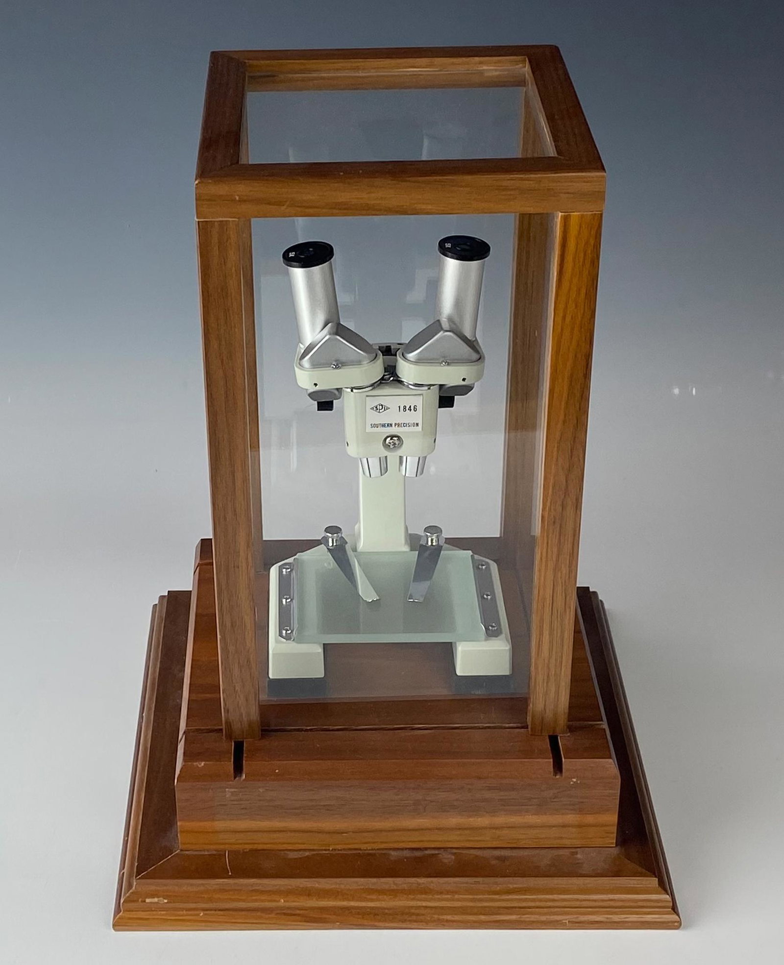 Southern Precision Lab Laboratory Microscope: Southern Precision Mechanical Laboratory Microscope Instrument mounted atop a stepped wooden base. The wheel moves smoothly and the magnification is good and clear. A removable plastic and wood dome n