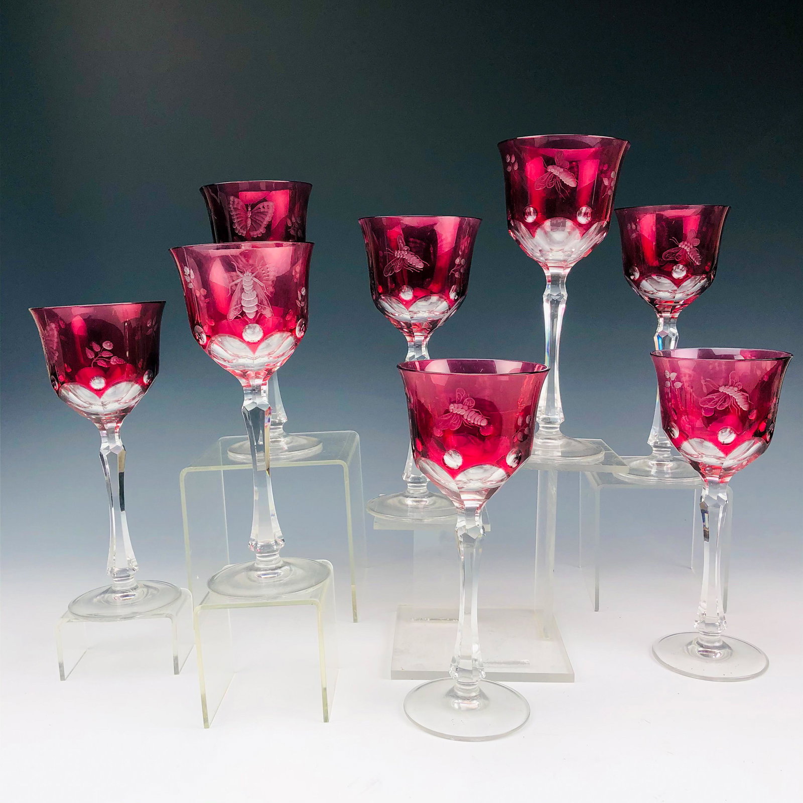 8 Cranberry Cut Clear Butterfly Wine Glass Goblets: Features a set of 8 Cranberry Glass Cut to Clear Bar Barware Wine Goblets. A deeply carved butterfly and a moth insect motif grace opposite sides of the body with carved floral stems and concave coin 