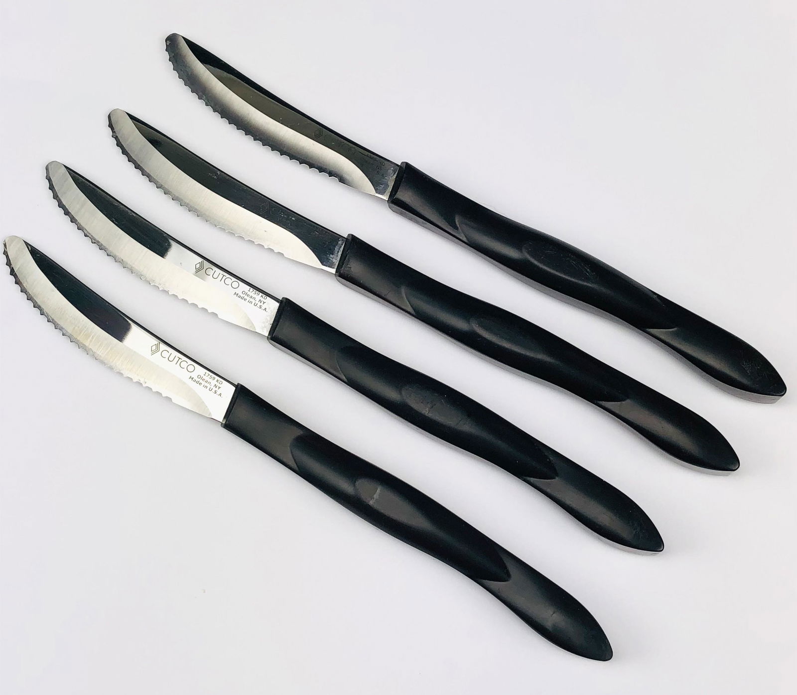 4 Cutco Model 1759 KD Serrated Table Steak Knifes: These Cutco's best selling knives modeled with a high carbon stainless DD serrated blade. Classic dark brown / black handles. Ideal choices even if steak isn't on one's menu. No box. Signed Cutco 1759