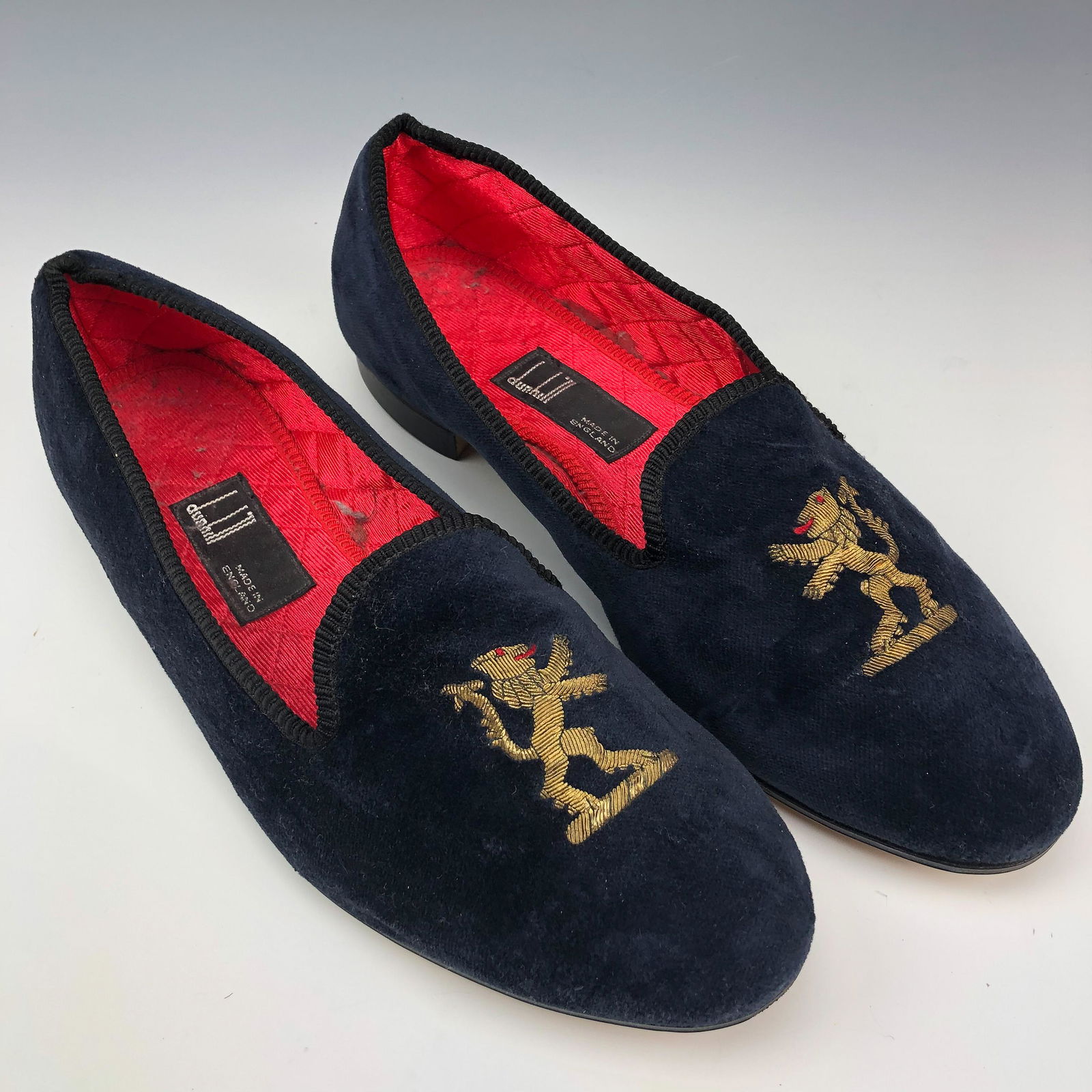 Dunhill Lion Motif Leather Velvet Smoking Slippers: Made of soft velvet, satin quilted lining and hard leather soles. Front of each with a hand embroidered design of a lion facing the right, the technique called "Gold Work" and involves a very fine fil