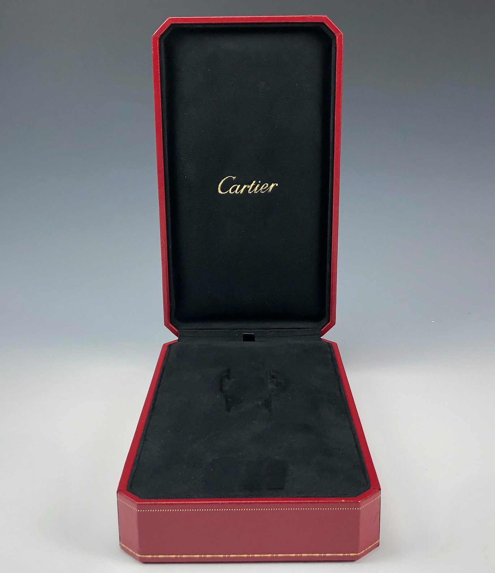 Genuine Cartier Red Leather Presentation Watch Box: Cartier Red Leather Presentation Wrist Watch Box. Nicely hinged. Interior lined with a black suede lining with the Cartier name in gold lettering. Gold stenciled design work on the rims. Preowned. Sig
