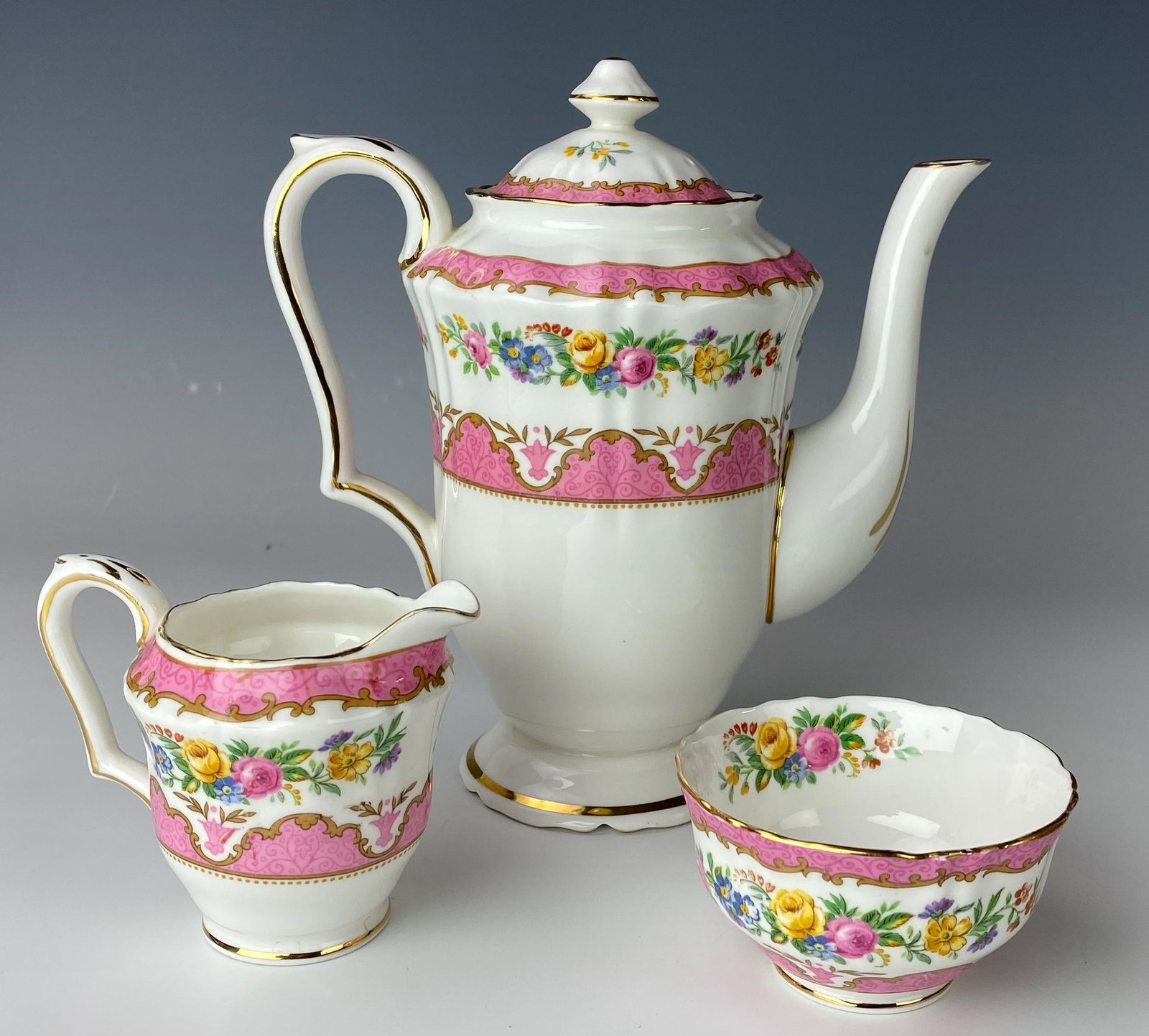 Crown Staffordshire Tea Coffeepot Sugar & Creamer: Includes a 3 piece set comprising of a lidded tea coffee pot, milk creamer jug and a round open sugar bowl. Pretty floral decorations with pink bands with scrolls grace all the articles, against a cri