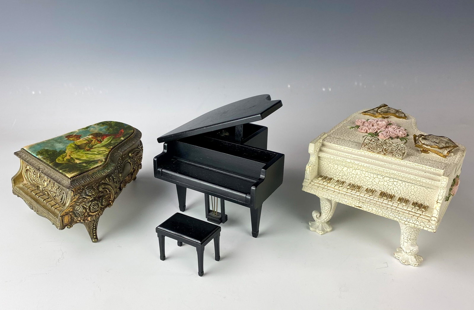 Collection Lot 3 Miniature Grand Piano Music Boxes: Wonderfully decorative WORKING music boxes, each designed as a Mini Grand Piano. All play a musical tune when wound. NO BOXES. Signed with paper sticker labels on the underside of 2. The silver toned 