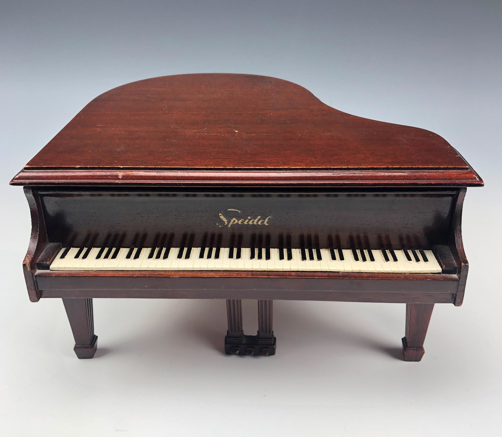 Speidel Mini Grand Piano Storage Trinket Music Box: Well crafted miniature dark colored wooden piano storage trinket jewelry musical box. Nicely hinged and when the lid it lifted, the box plays a happy musical tune. NO box. Warm original patina. Signed
