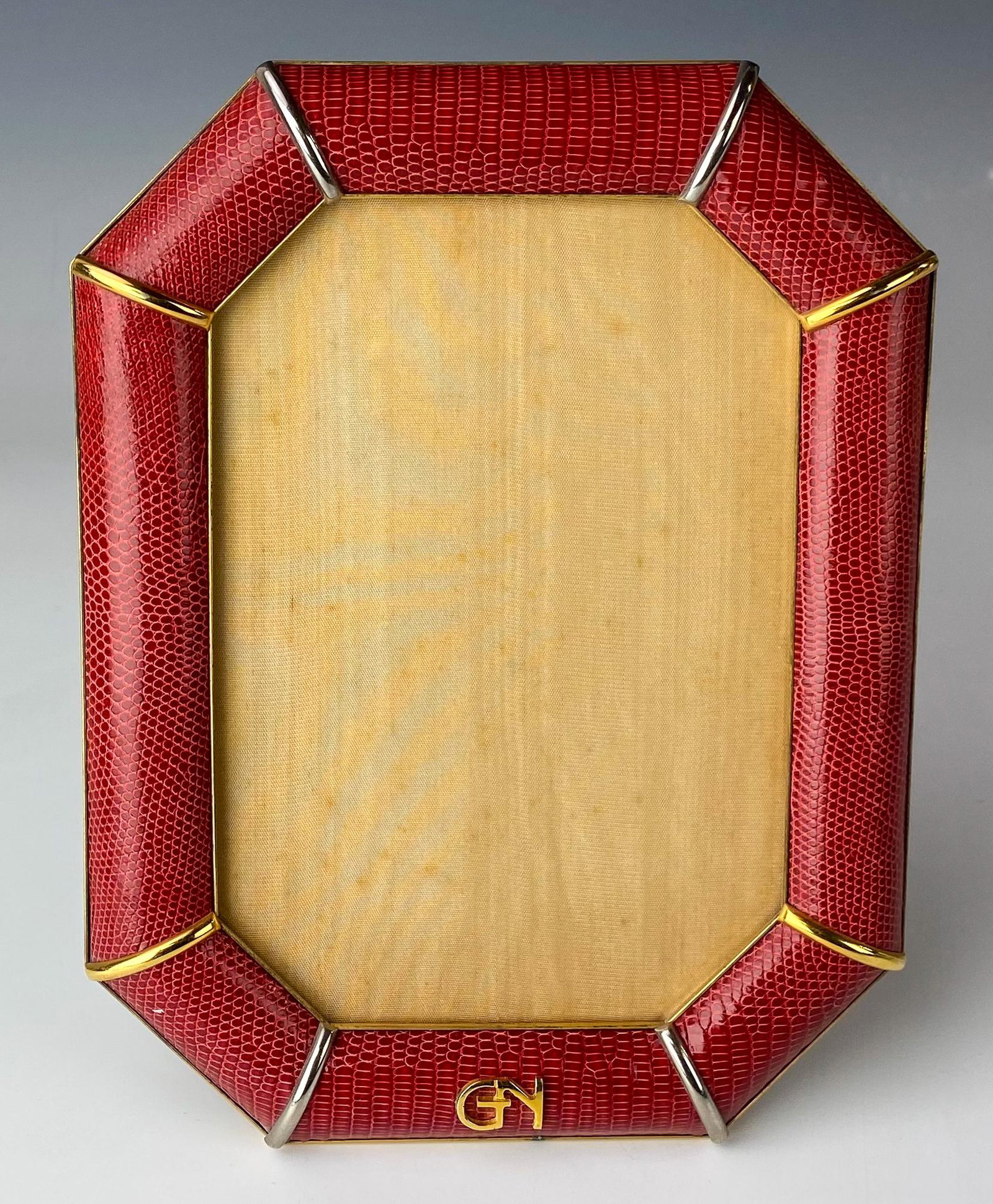 Galleria Novita Italy Gold Tone Snake Skin Frame: Beautifully well crafted article of mixed media. The gold gilt octagonal shape frame graced with a red colored snake skin style accent. Silver toned easel back stand. NO Box. Signed with label on vers