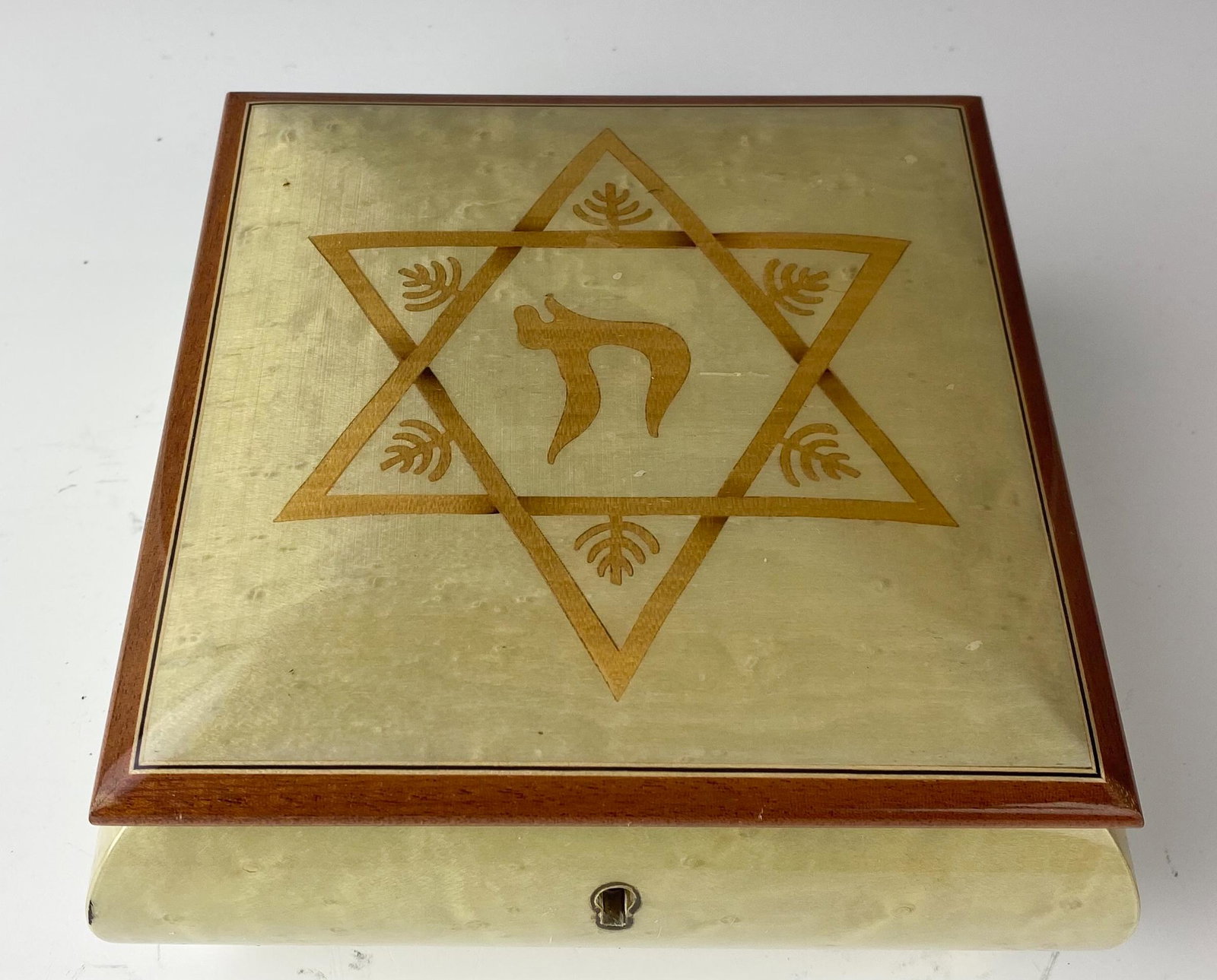 Reuge Italy Inlay Wood Trinket Storage Music Box: Inlaid wooden jewelry storage trinket music box features The Star of David and the Hebrew symbol in the center, on the top. Nicely hinged. Comes with it's key that works smoothly. Velvet lined interio