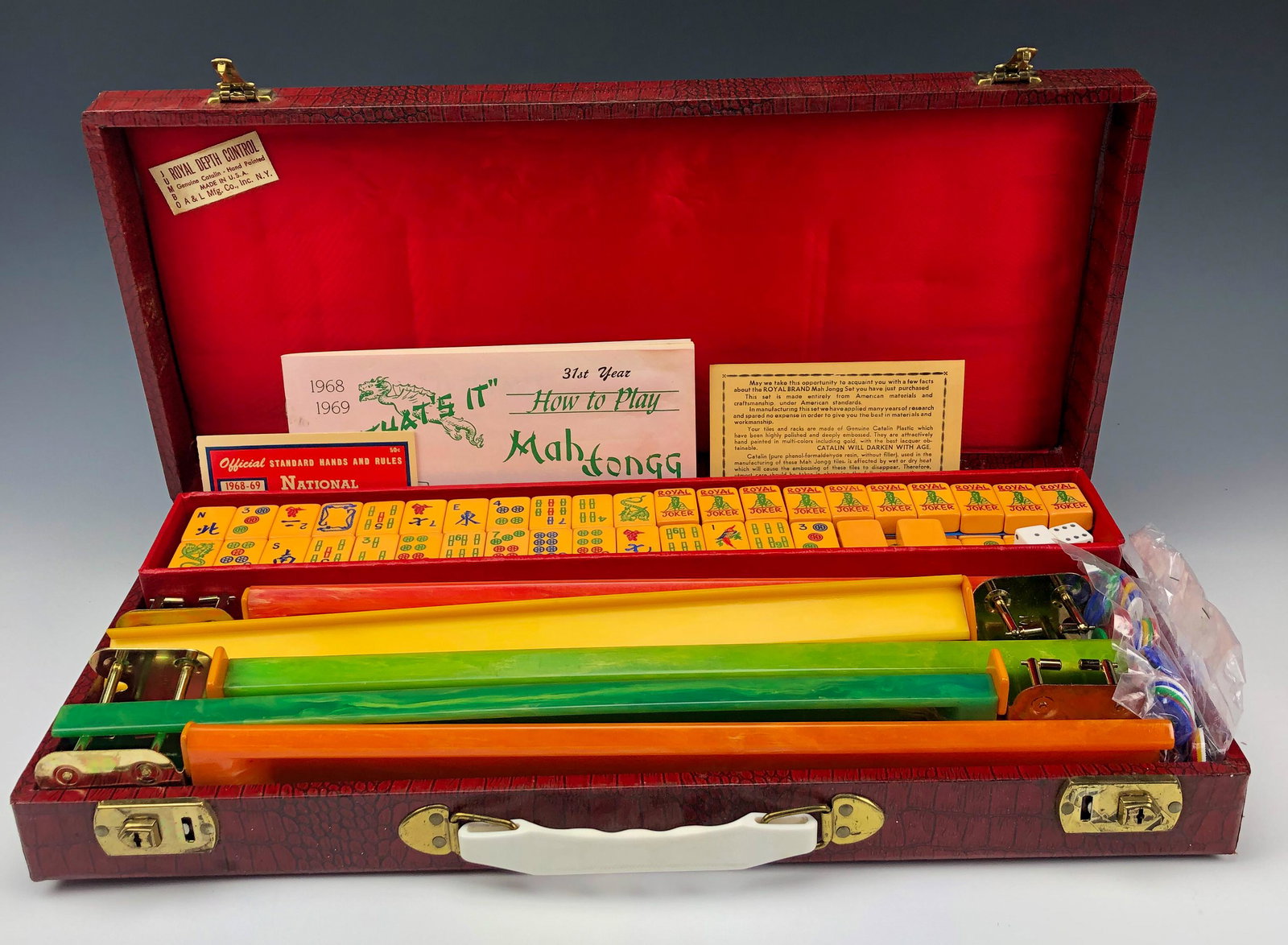 Mahjong Royal Depth 164 Tile Board Game Set w Case: Royal Depth Control Mahjong Board Game Set with a total of 164 Acrylic / Plastic Tiles and 5 Colored Racks. Of the 164 tiles, there are 10 jokers and 2 blanks. All securely housed in a red colored har