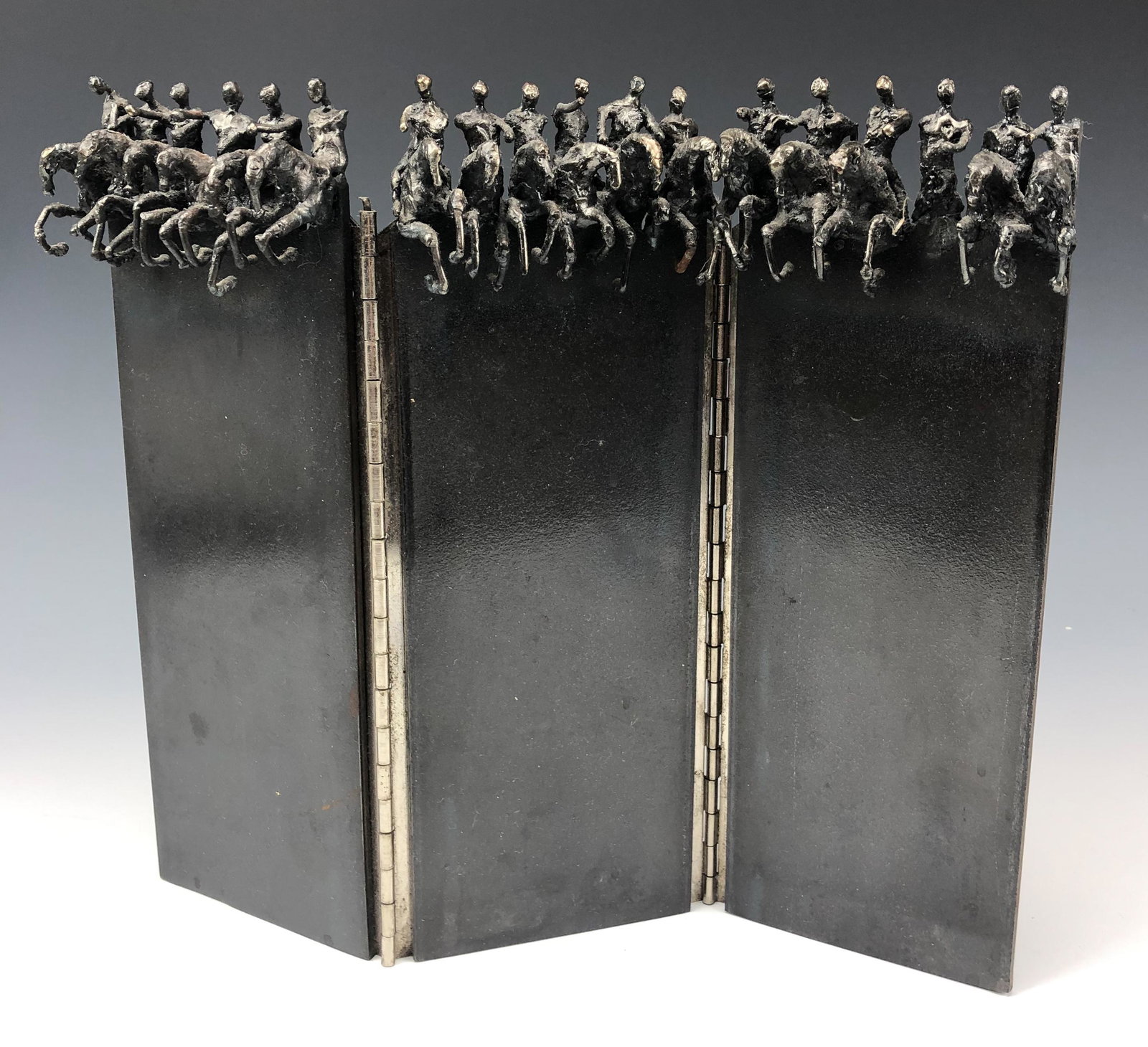 3 Panel Hand Crafted Steel Equestrian Table Screen: Painstakingly hand crafted in manner and nicely hinged. Top of each panel features a man riding his horse. Remainder of the panels with a smooth polished finish. Signed B. 1990. Estate fresh condition