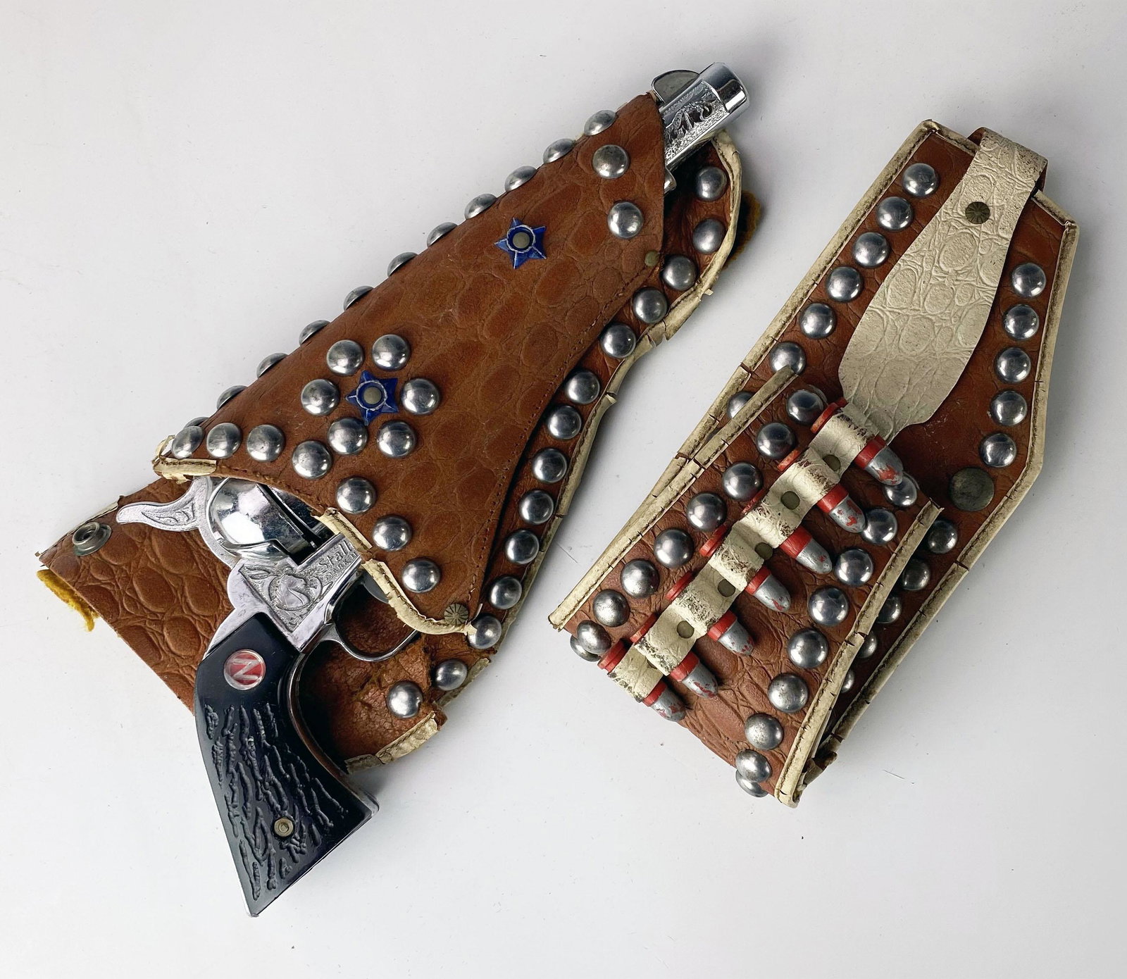 Nichols Stallion 45 Mark II Toy Cap Gun w/ Bullets: Cool and fun REPLICA toy cap gun produced by Nichols. Circa 1950's. Appears to be complete although NON functional. Gun is in a leather studded holder. Comes with a leather belt with toy bullets. Both