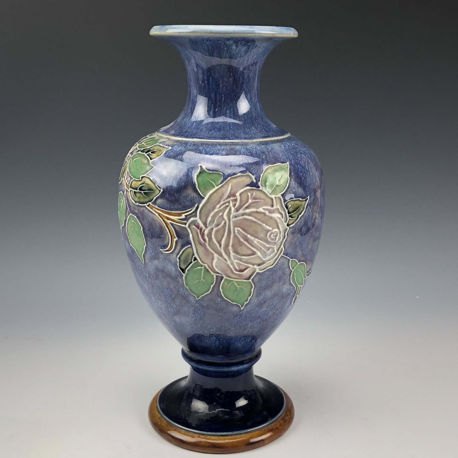 Royal Doulton Lambeth Tube Lined Stoneware Vase: Nice Large Royal Doulton English Ceramic Stoneware Pottery Shelf Mantle Vase. Decorated by Joan Honey. Modeled with a warm nature inspired art Nouveau inspired theme. Features a tube lined fully bloom