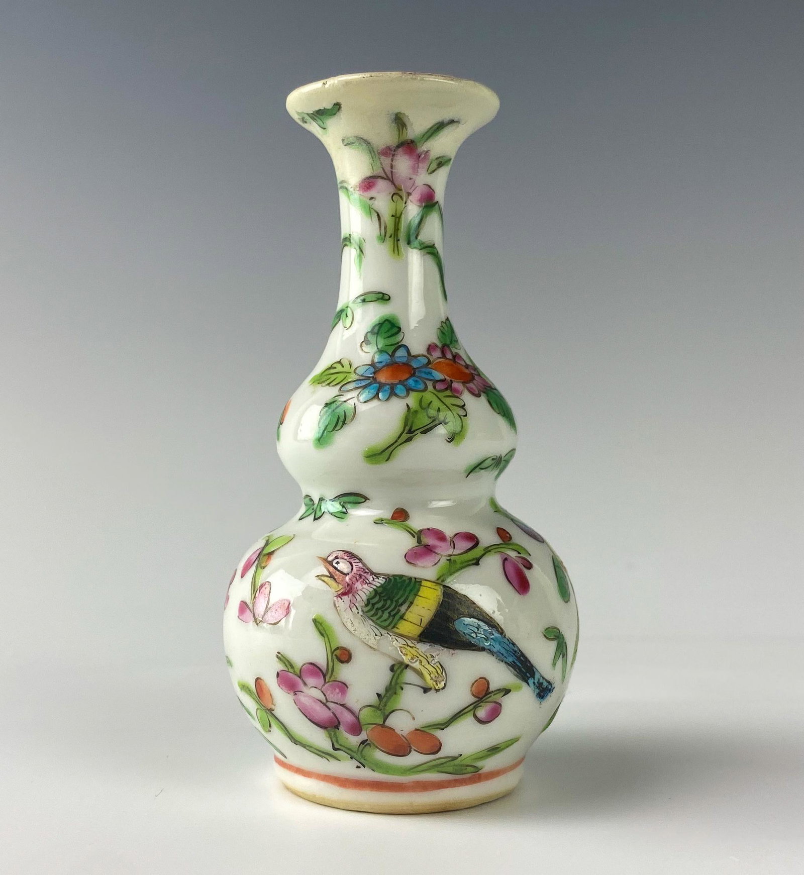 Chinese Porcelain Enamel Butterfly Bird Bud Vase: Double gourd form. Hand painted butterfly and bird design with floral decorations against white ground. Unsigned. Good estate fresh condition. Measures 4 in. MMB Inc. in house USA continental shipping