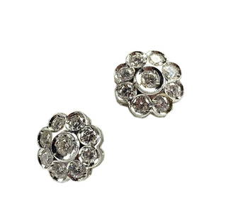 18K White Gold and Diamond Cluster Flower Earring: 18K White Gold Diamond Cluster Flower Stud Earrings. .60ct t.w. This pair of earrings contains 9 round brilliant cut diamonds, each diamond measuring 2mm, total carat weight .60 cts.18k Mecan La