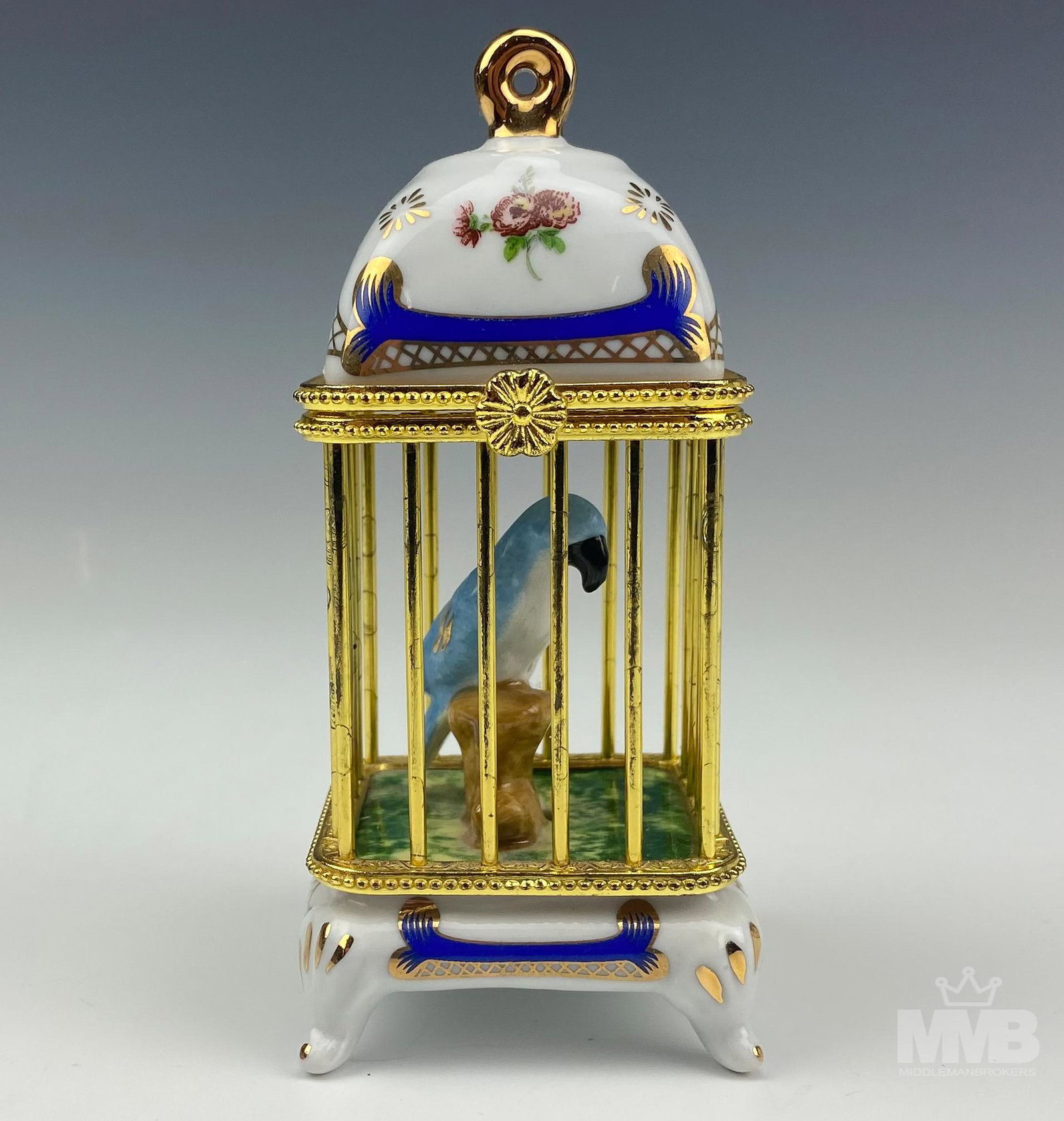 Limoges Style Imperial Gilt Parrot Bird Cage Box: Limoges Style Imperial Gold Gilt Parrot Footed Bird Cage Box. Colorful light blue parrot in gold cage. Top lifts easily to reveal parrot resting on branch. Gold gilt accents on bird and ornate hand-pa