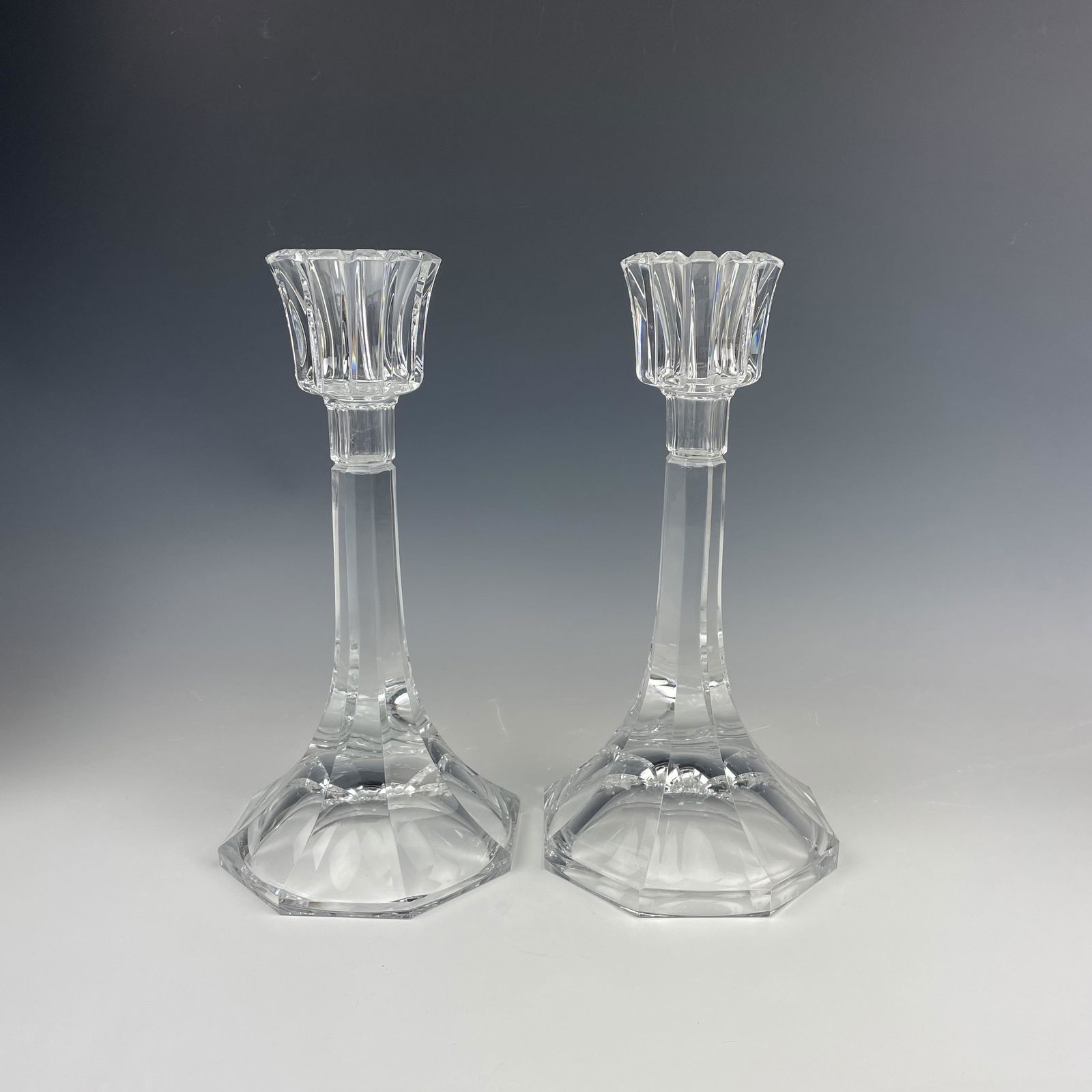 Orrefors Glass Crystal Stenhammer Candleholders: Pair of Stenhammer candleholders by Orrefors. Signed on base. Good overall condition with mild storage wear. Measures approximately 12 in. x 6 in. x 6 in. MMB in house USA continental shipping $55 plu
